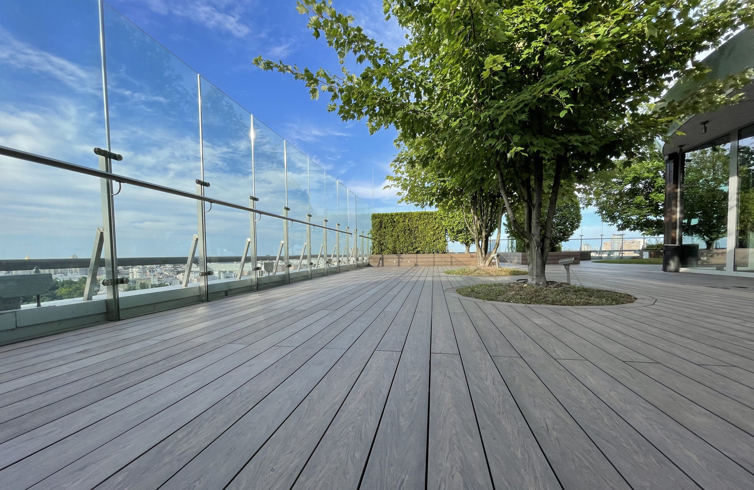 Rooftop landscape park in Kyiv with BRUGGAN Multicolor Wenge composite decking and integrated planters