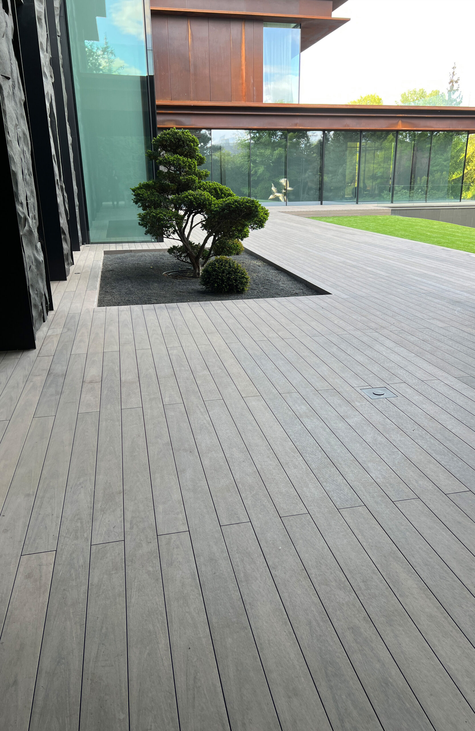 BRUGGAN Multicolor Wenge decking around a modern villa with landscaped garden in Kyiv