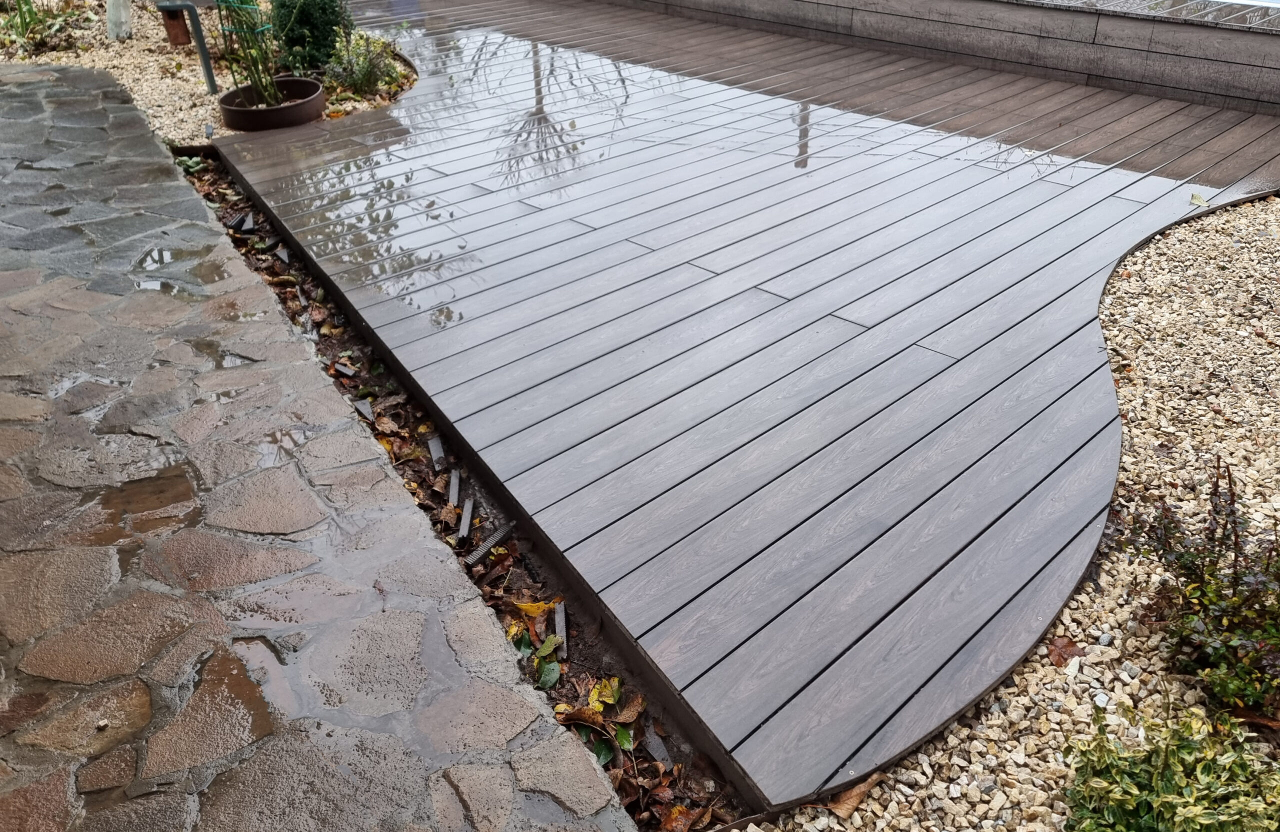 BRUGGAN Multicolor Wenge outdoor decking surrounding a raised swimming pool in a private backyard