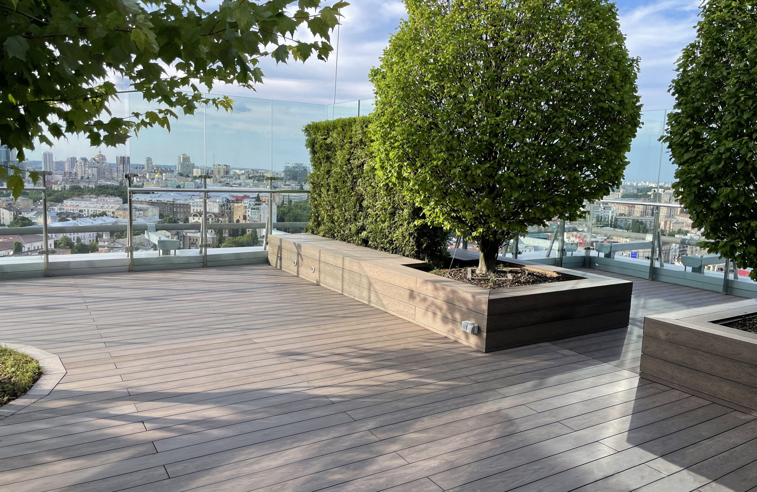 Rooftop landscape park in Kyiv with BRUGGAN Multicolor Wenge composite decking and integrated planters