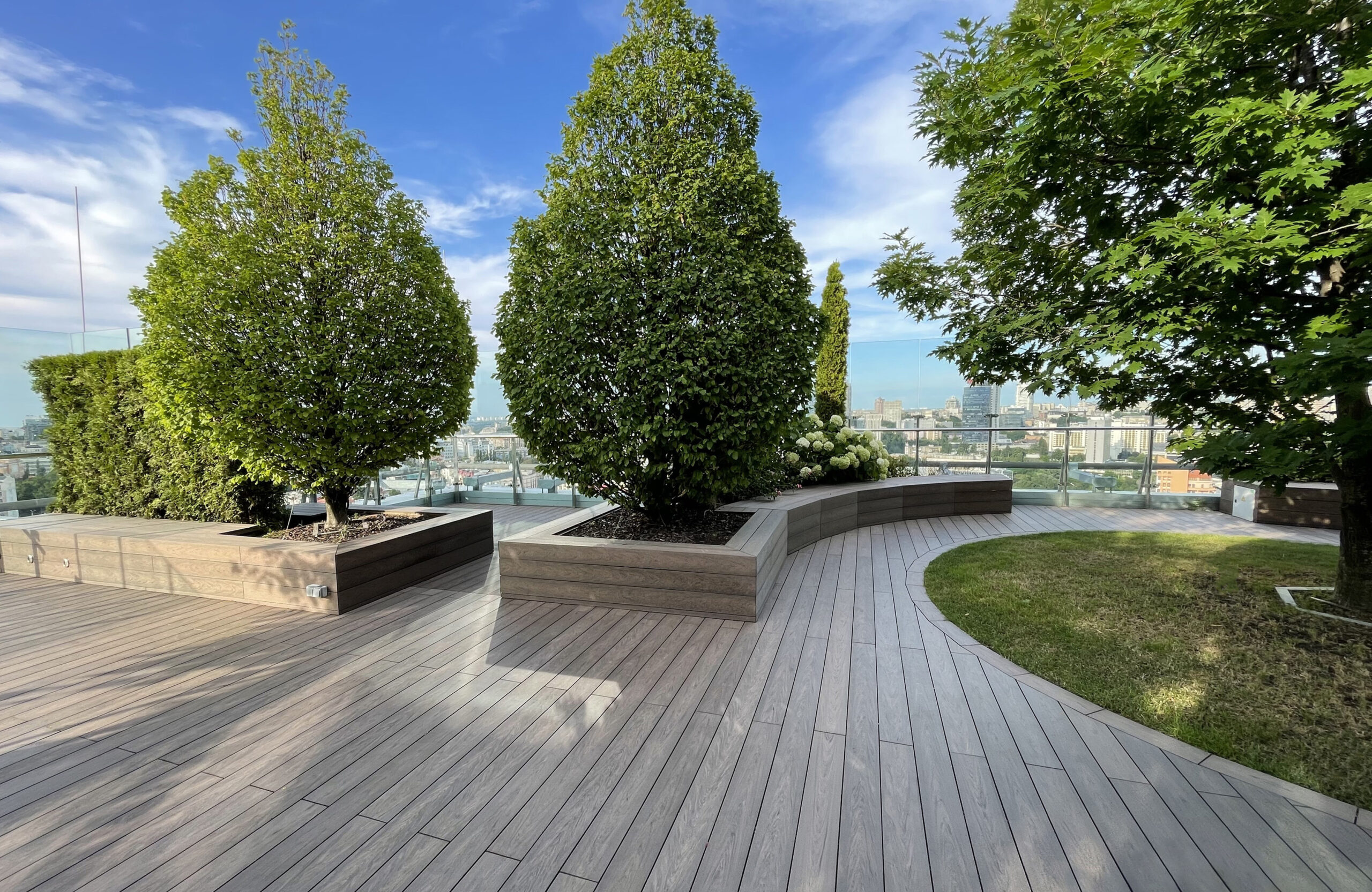Rooftop landscape park in Kyiv with BRUGGAN Multicolor Wenge composite decking and integrated planters