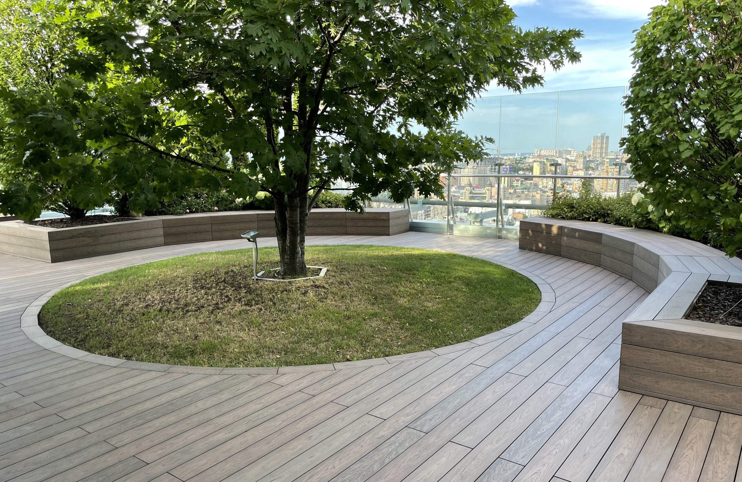 Rooftop landscape park in Kyiv with BRUGGAN Multicolor Wenge composite decking and integrated planters