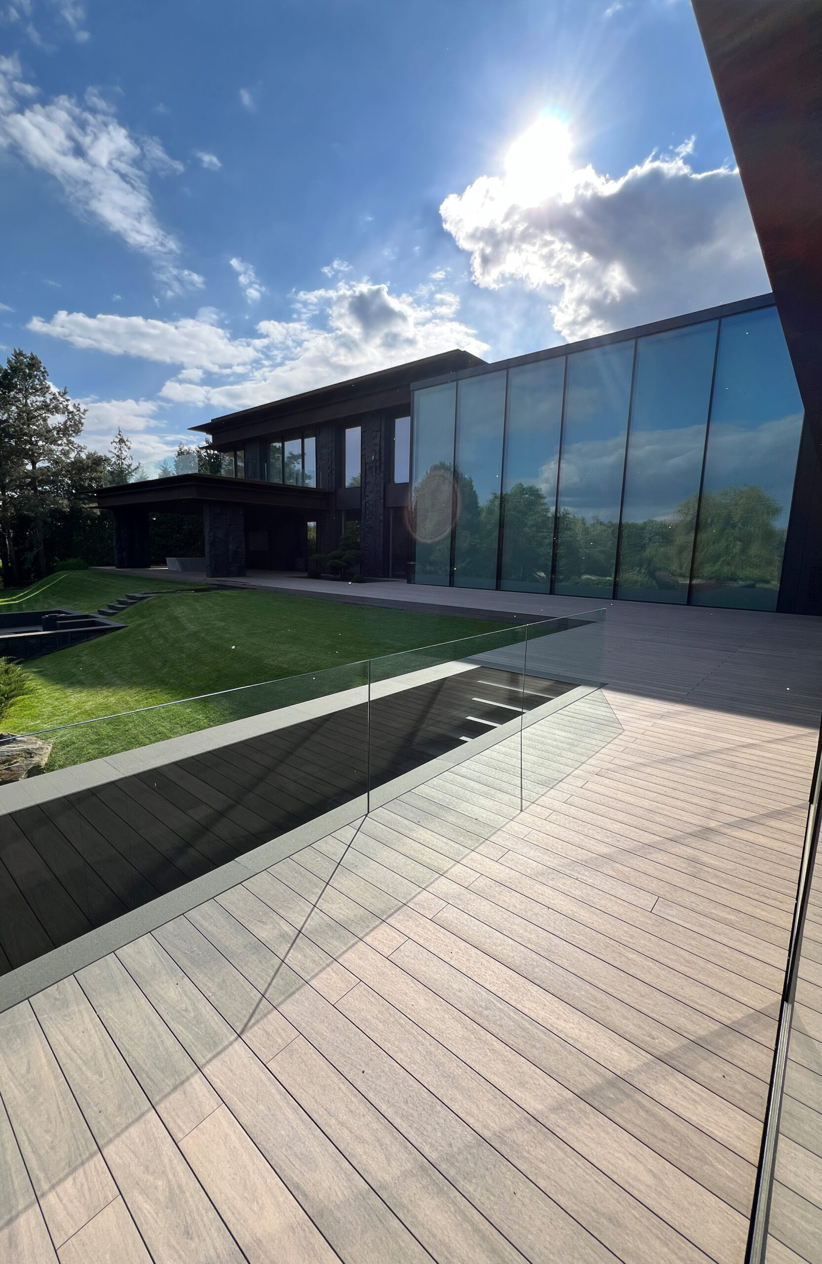 BRUGGAN Multicolor Wenge decking around a modern villa with landscaped garden in Kyiv