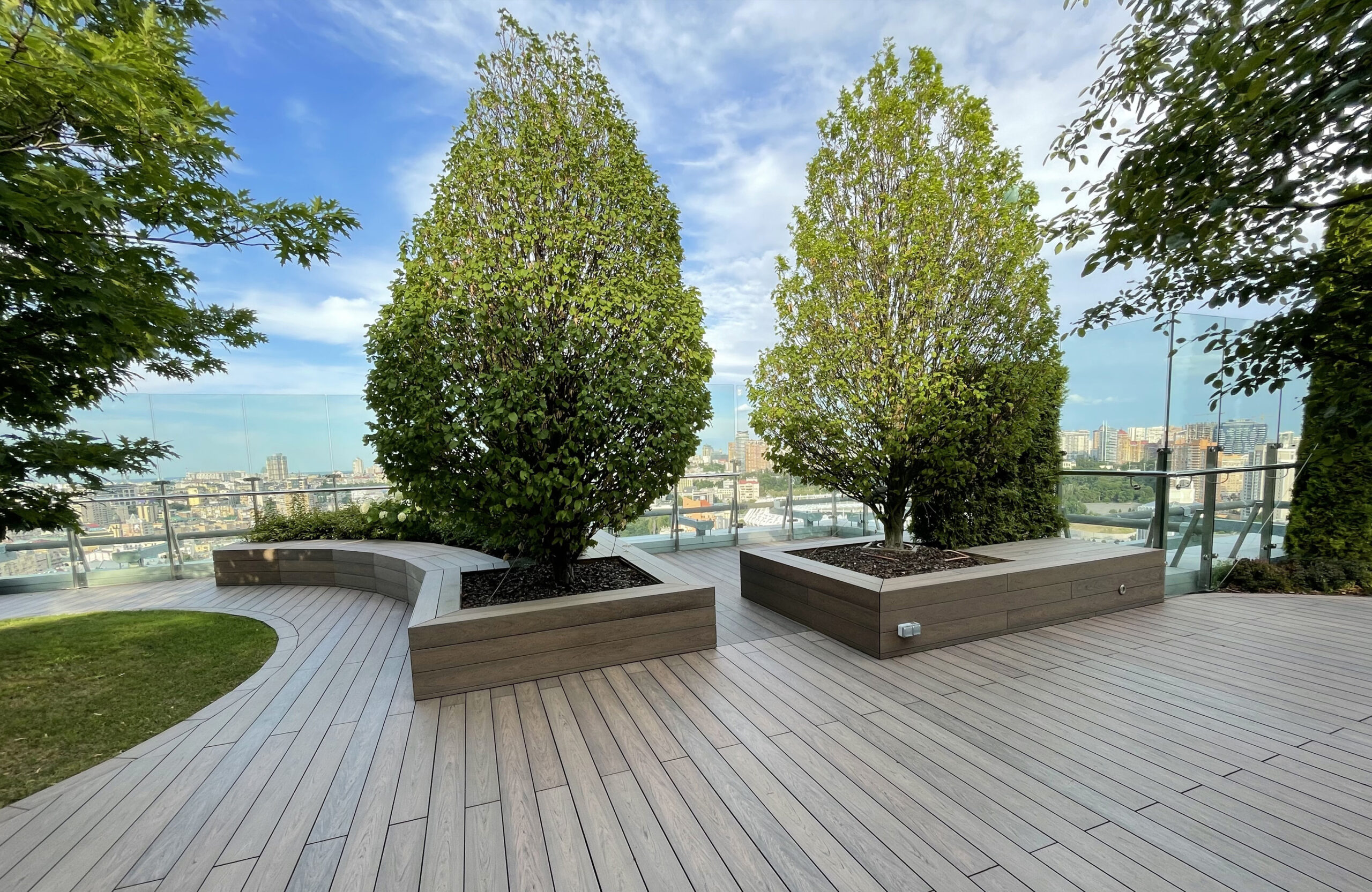 Rooftop landscape park in Kyiv with BRUGGAN Multicolor Wenge composite decking and integrated planters