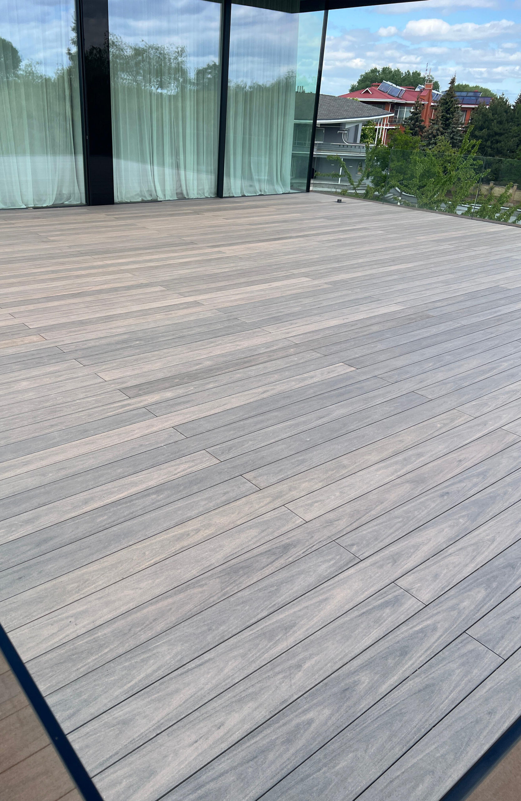 BRUGGAN Multicolor Wenge decking around a modern villa with landscaped garden in Kyiv
