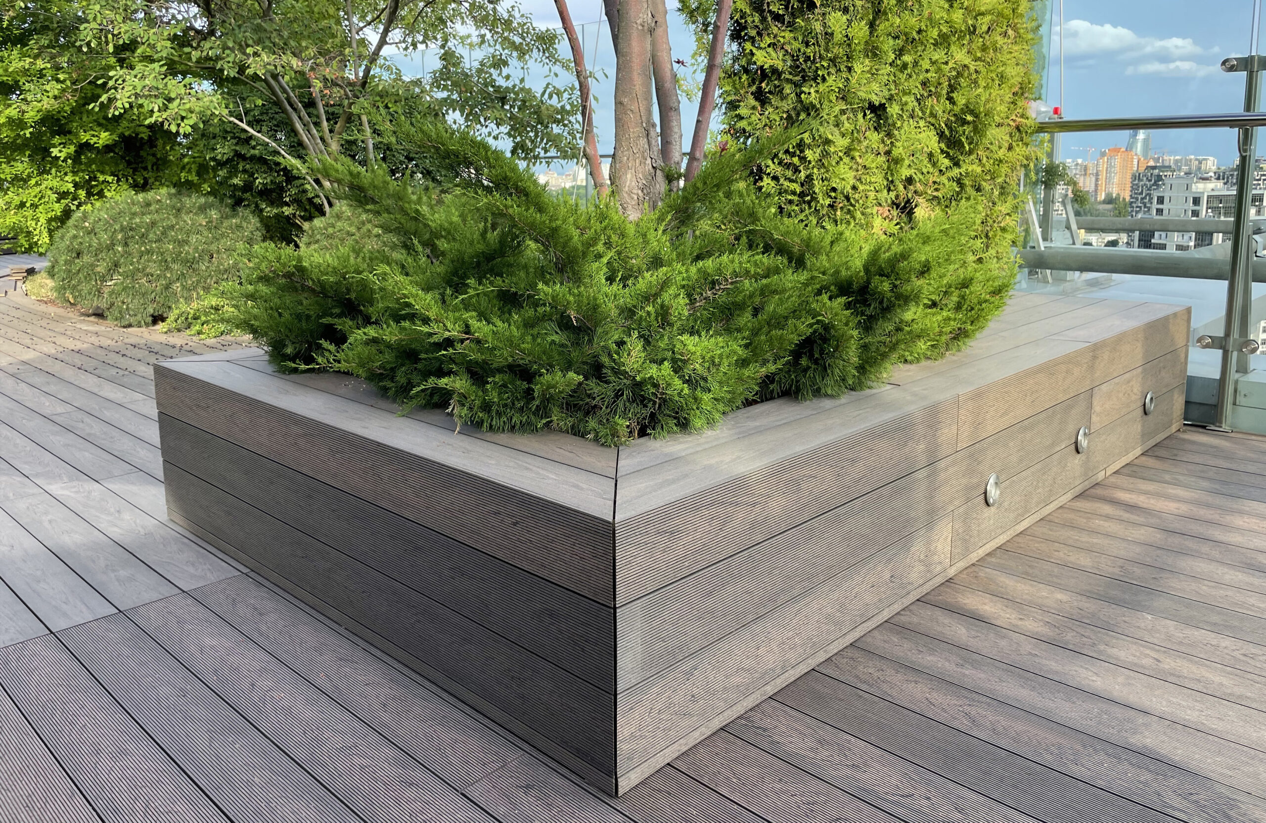 Rooftop landscape park in Kyiv with BRUGGAN Multicolor Wenge composite decking and integrated planters
