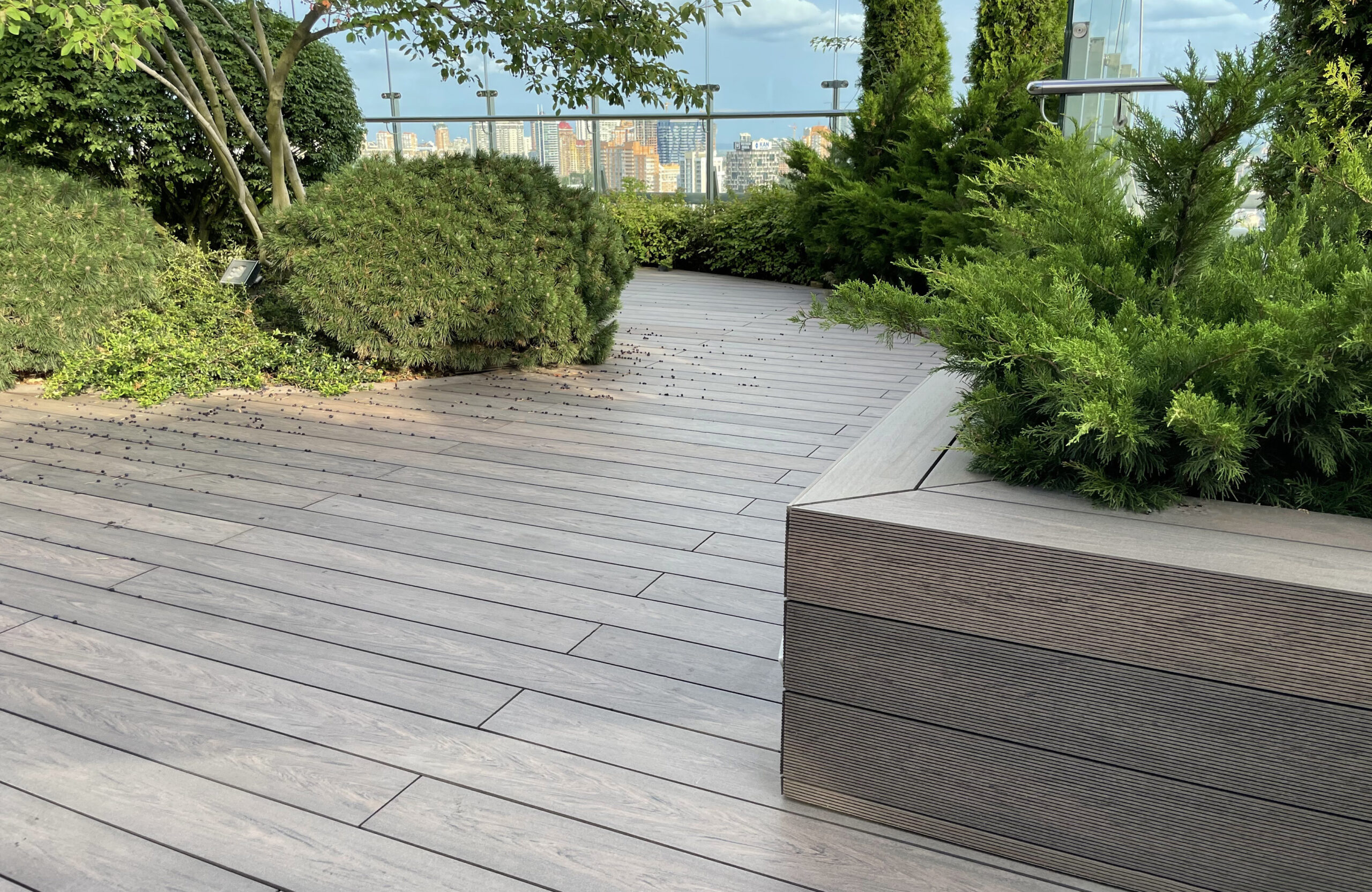 Rooftop landscape park in Kyiv with BRUGGAN Multicolor Wenge composite decking and integrated planters