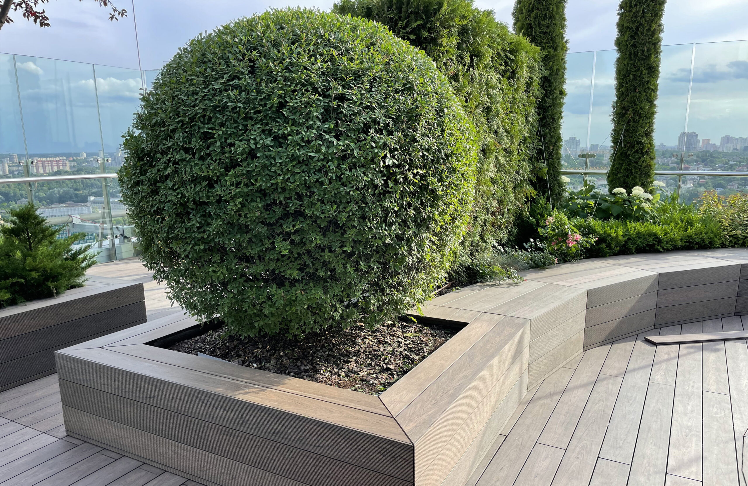Rooftop landscape park in Kyiv with BRUGGAN Multicolor Wenge composite decking and integrated planters