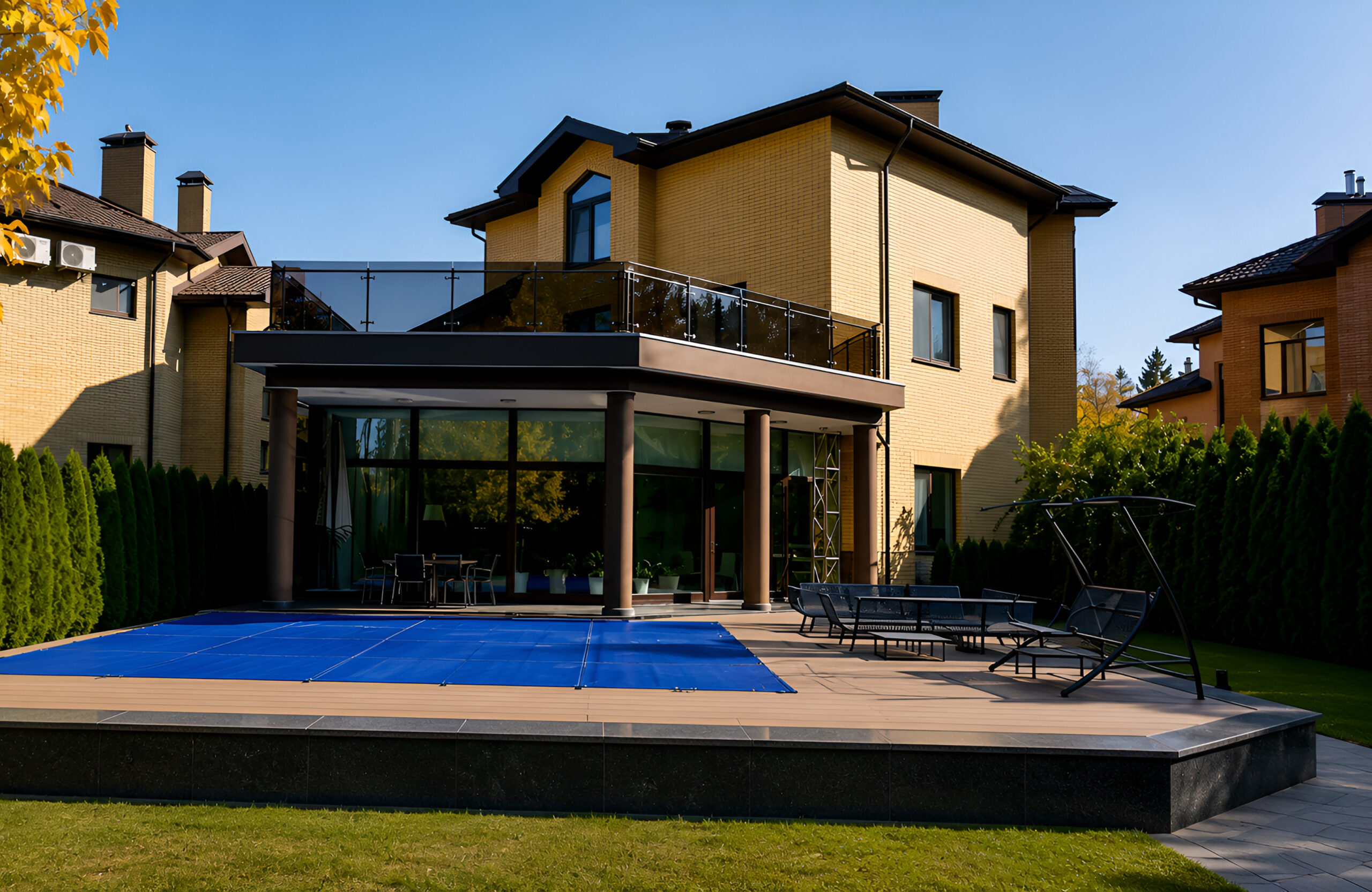 BRUGGAN Multicolor Wenge composite decking around a private swimming pool and outdoor lounge area