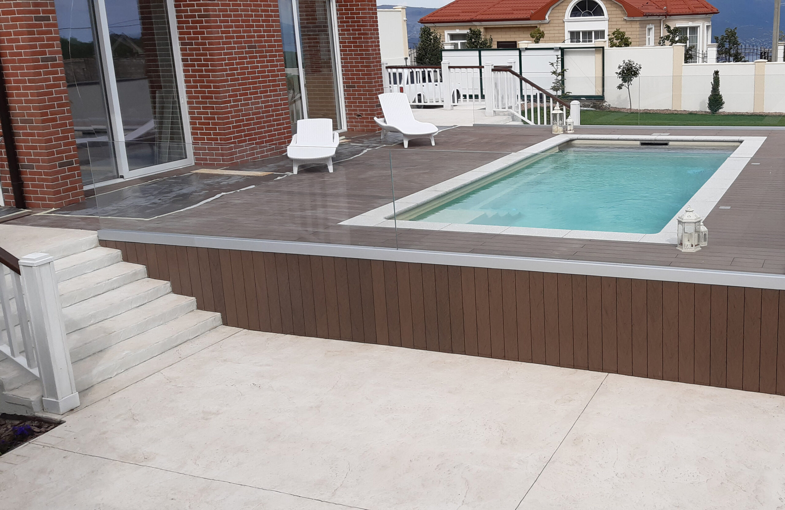 Private swimming pool area finished with BRUGGAN Multicolor Wenge outdoor decking
