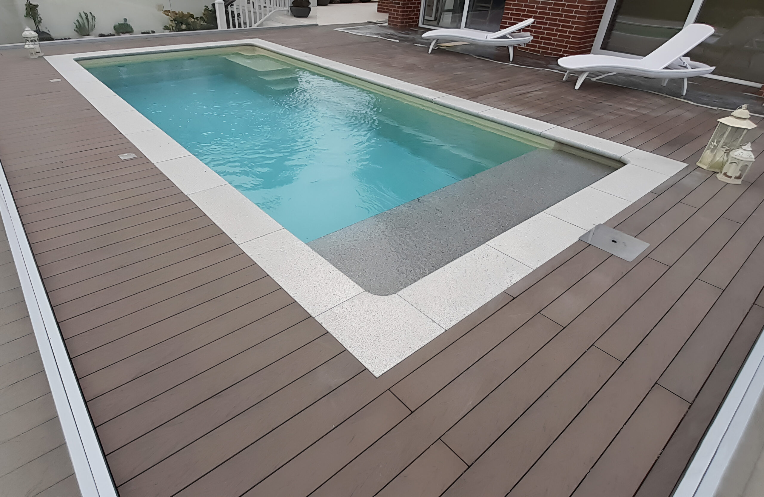 Private swimming pool area finished with BRUGGAN Multicolor Wenge outdoor decking