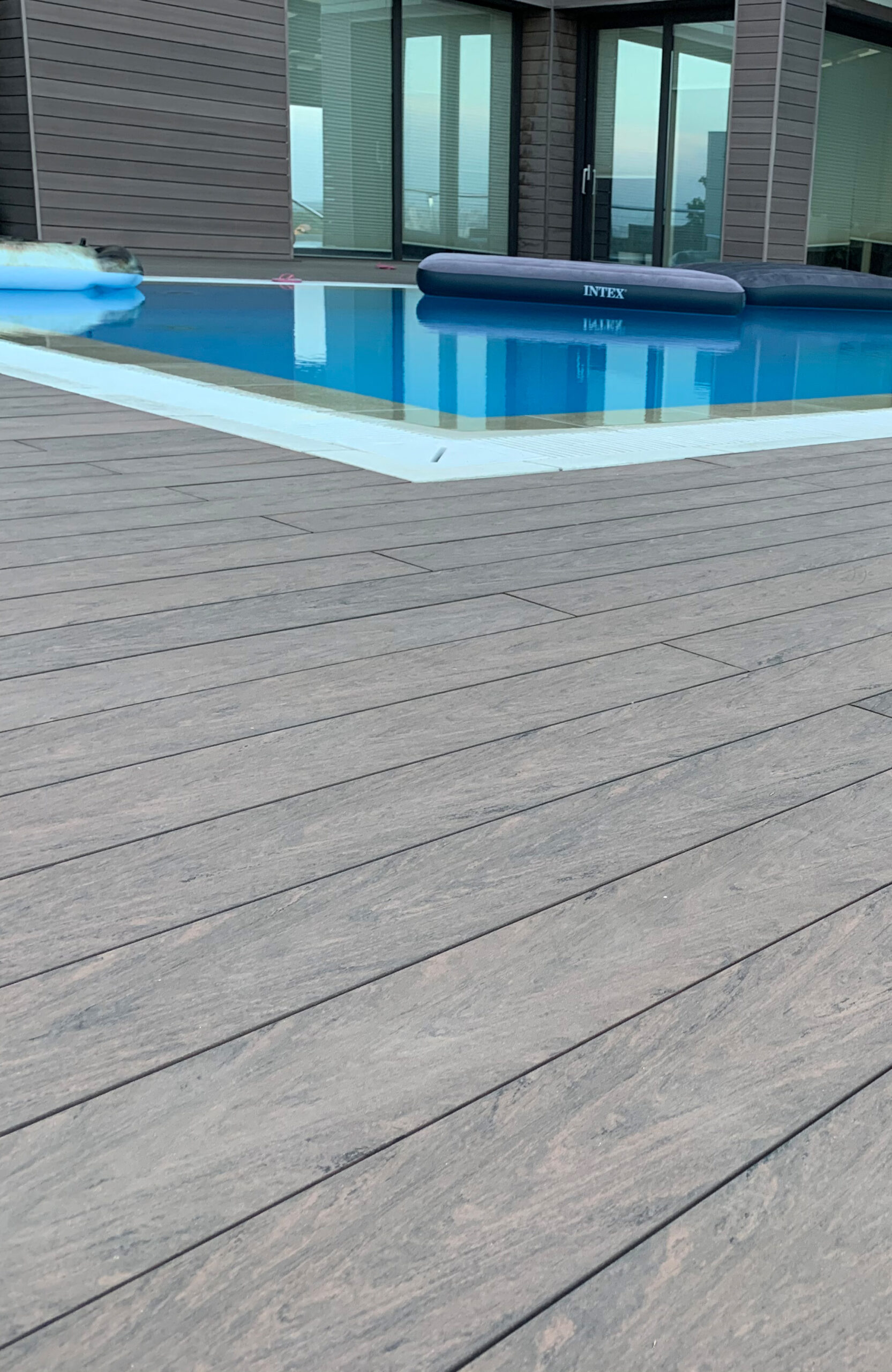 Modern pool terrace finished with BRUGGAN Multicolor Wenge decking at a private residence