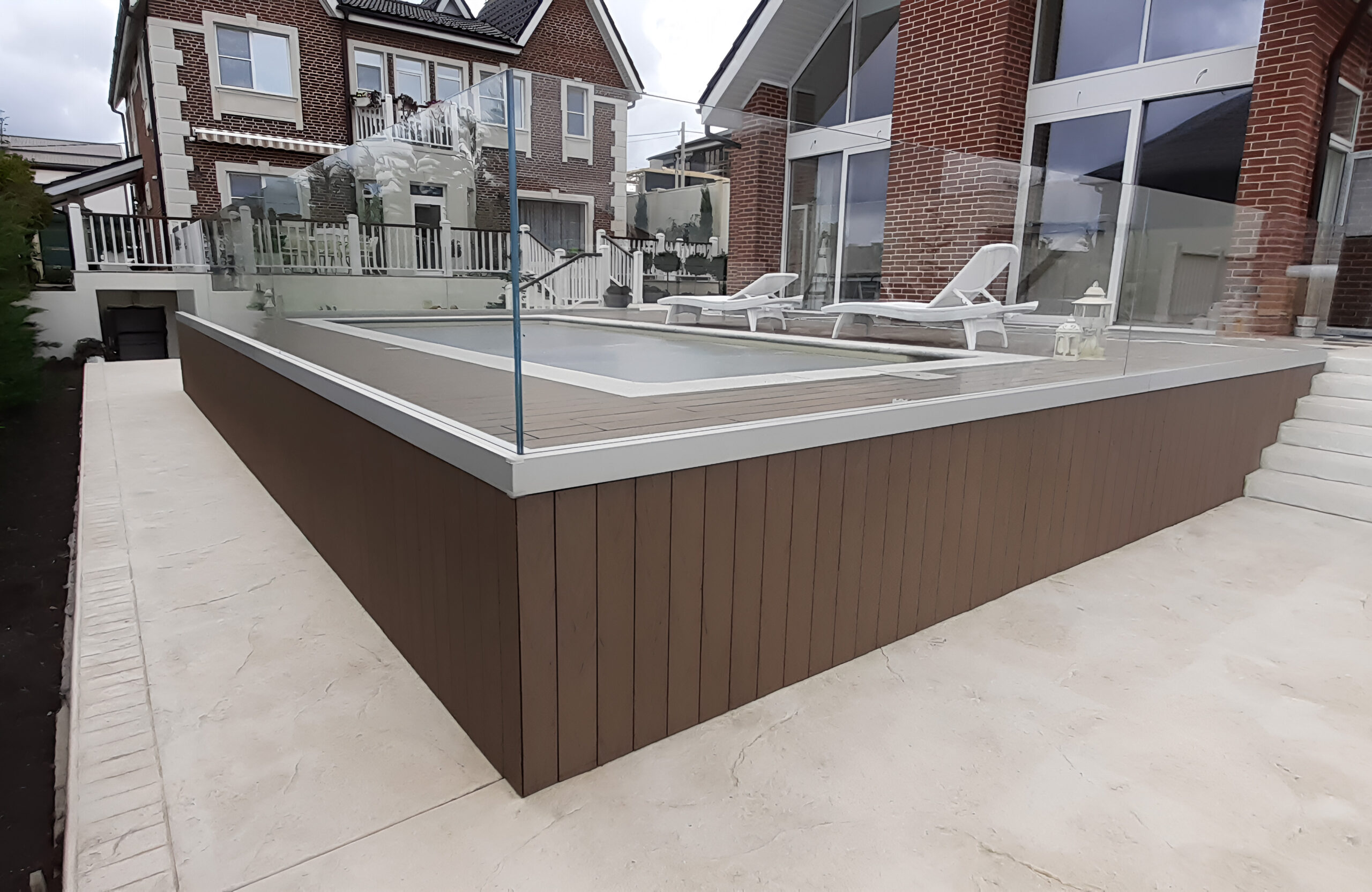 Private swimming pool area finished with BRUGGAN Multicolor Wenge outdoor decking