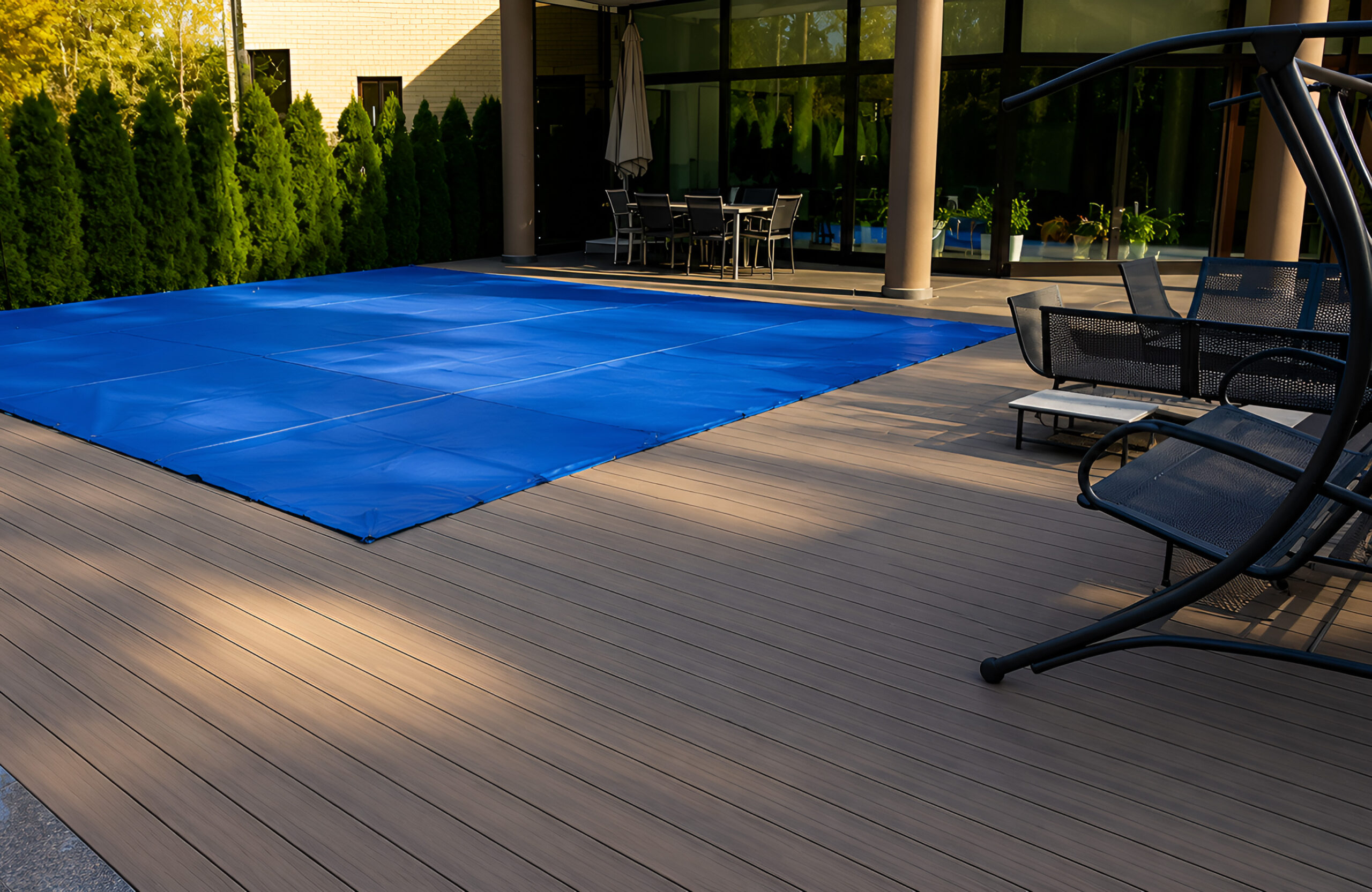 BRUGGAN Multicolor Wenge composite decking around a private swimming pool and outdoor lounge area