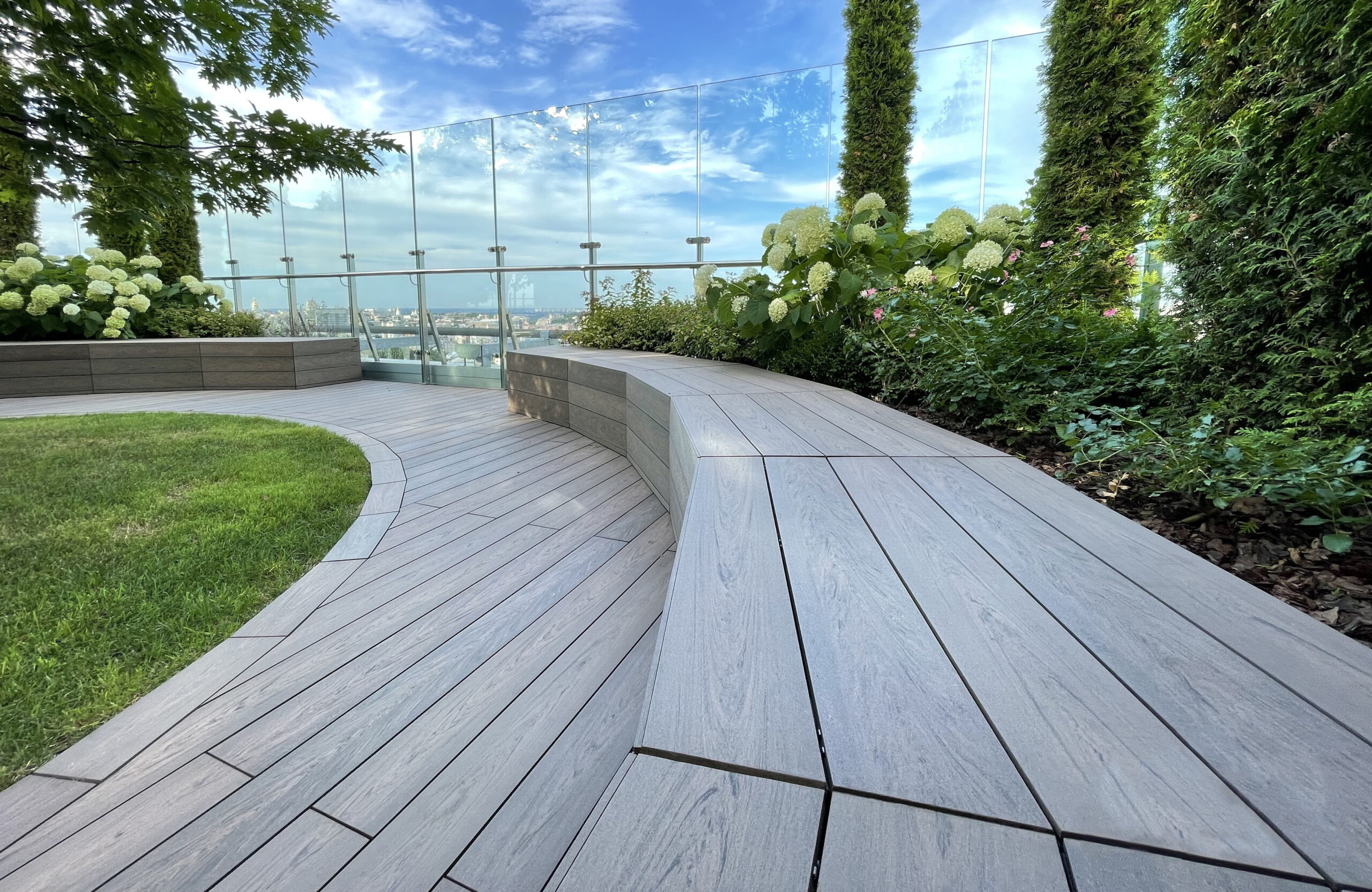 Rooftop landscape park in Kyiv with BRUGGAN Multicolor Wenge composite decking and integrated planters