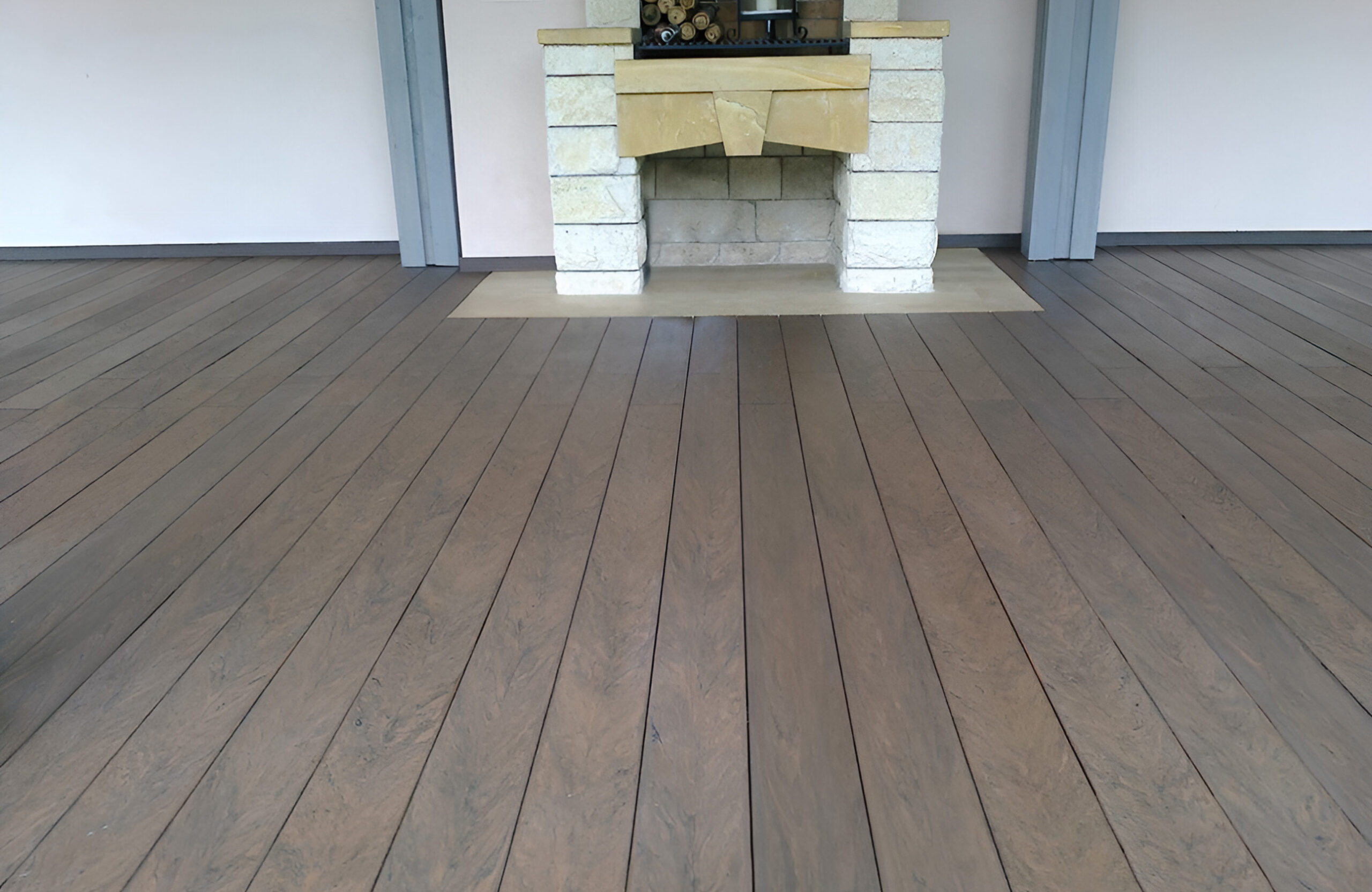 BRUGGAN Multicolor Wenge outdoor decking surrounding a covered patio with a stone fireplace