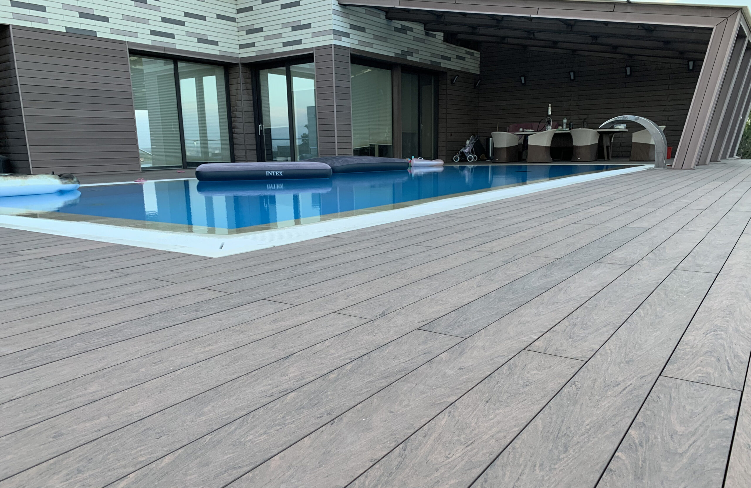 Modern pool terrace finished with BRUGGAN Multicolor Wenge decking at a private residence