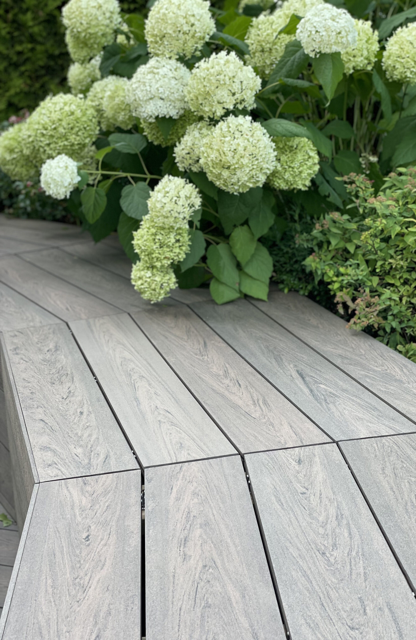 Rooftop landscape park in Kyiv with BRUGGAN Multicolor Wenge composite decking and integrated planters