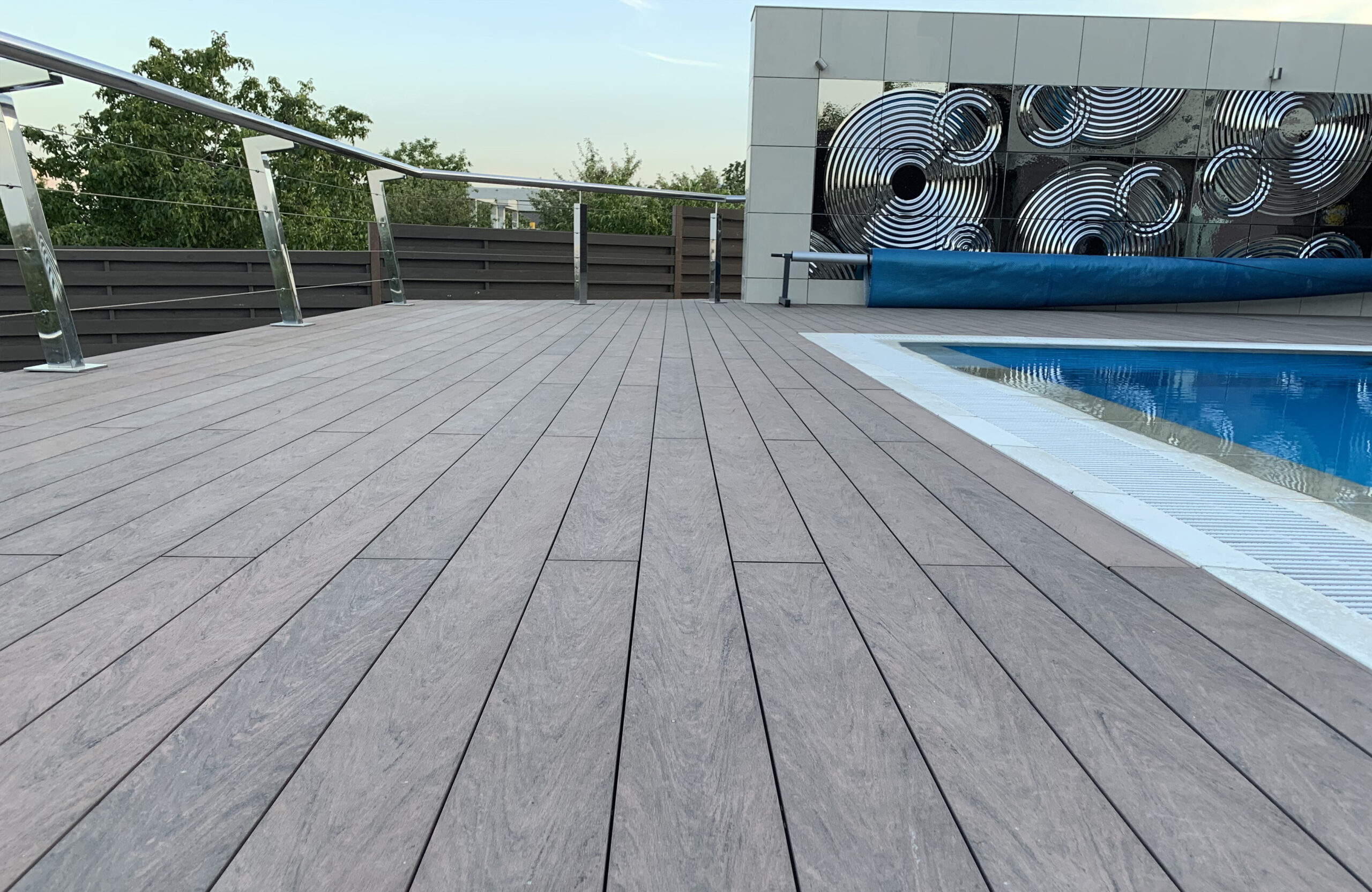 Modern pool terrace finished with BRUGGAN Multicolor Wenge decking at a private residence