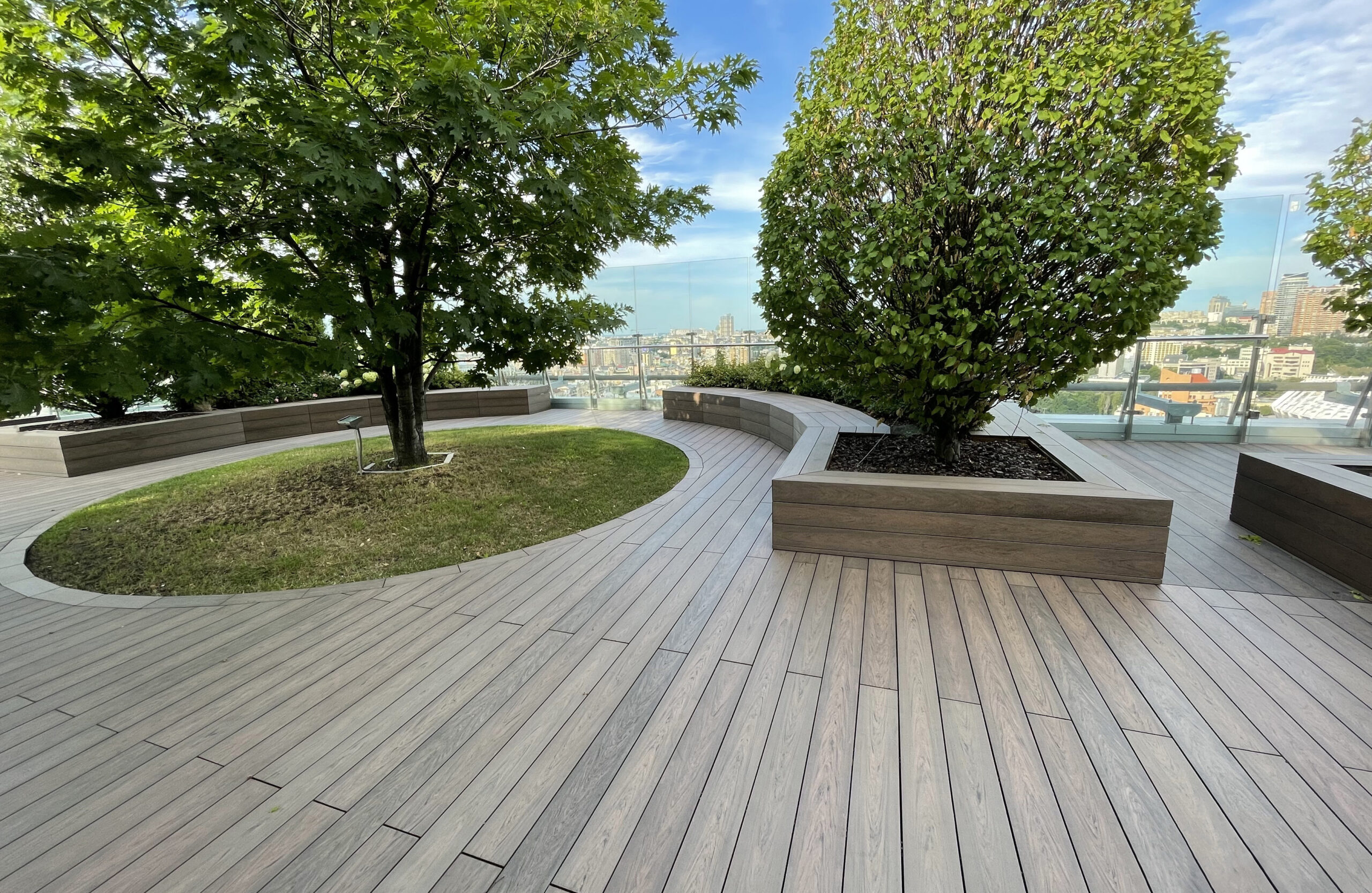 Rooftop landscape park in Kyiv with BRUGGAN Multicolor Wenge composite decking and integrated planters