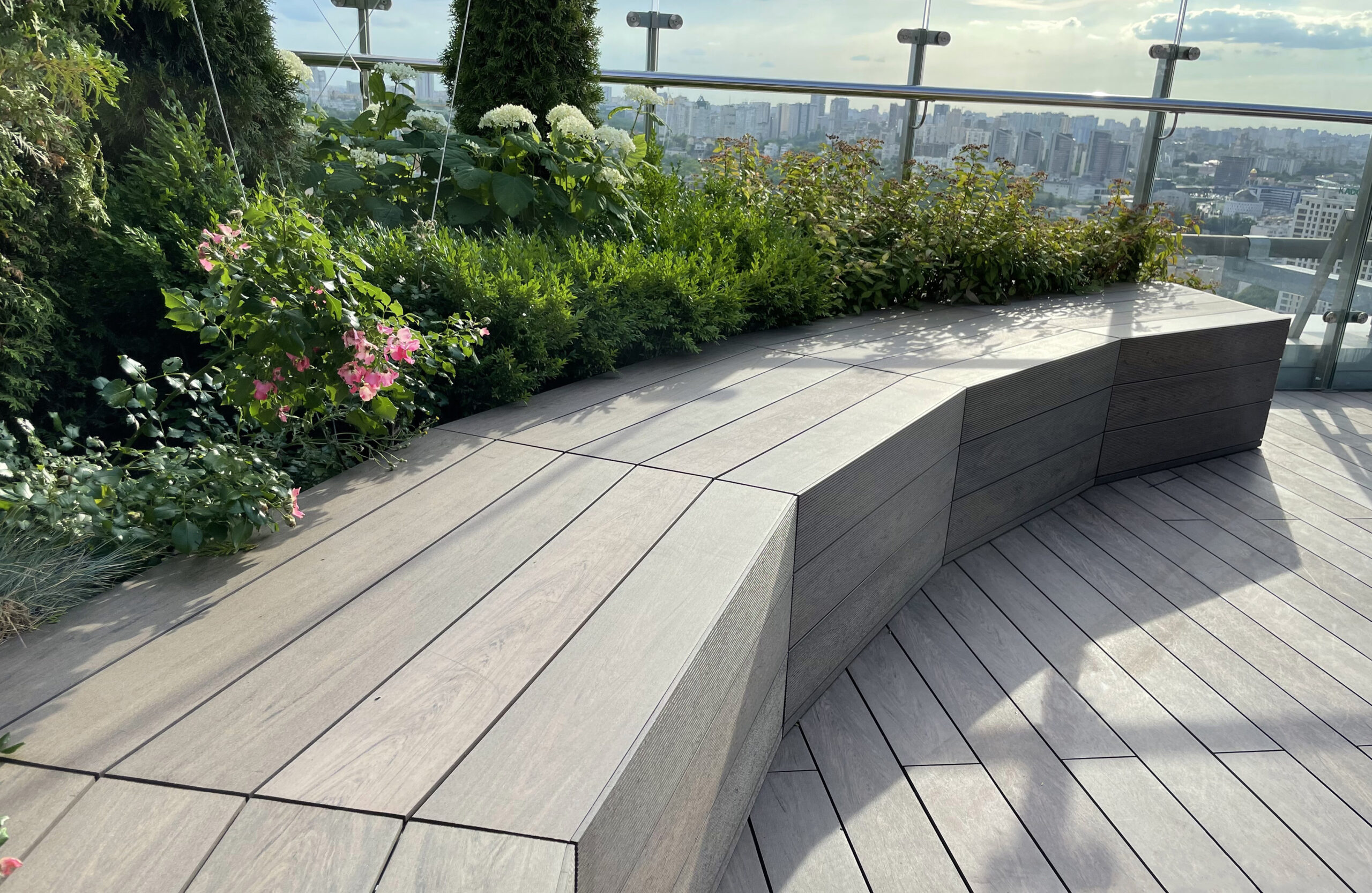 Rooftop landscape park in Kyiv with BRUGGAN Multicolor Wenge composite decking and integrated planters