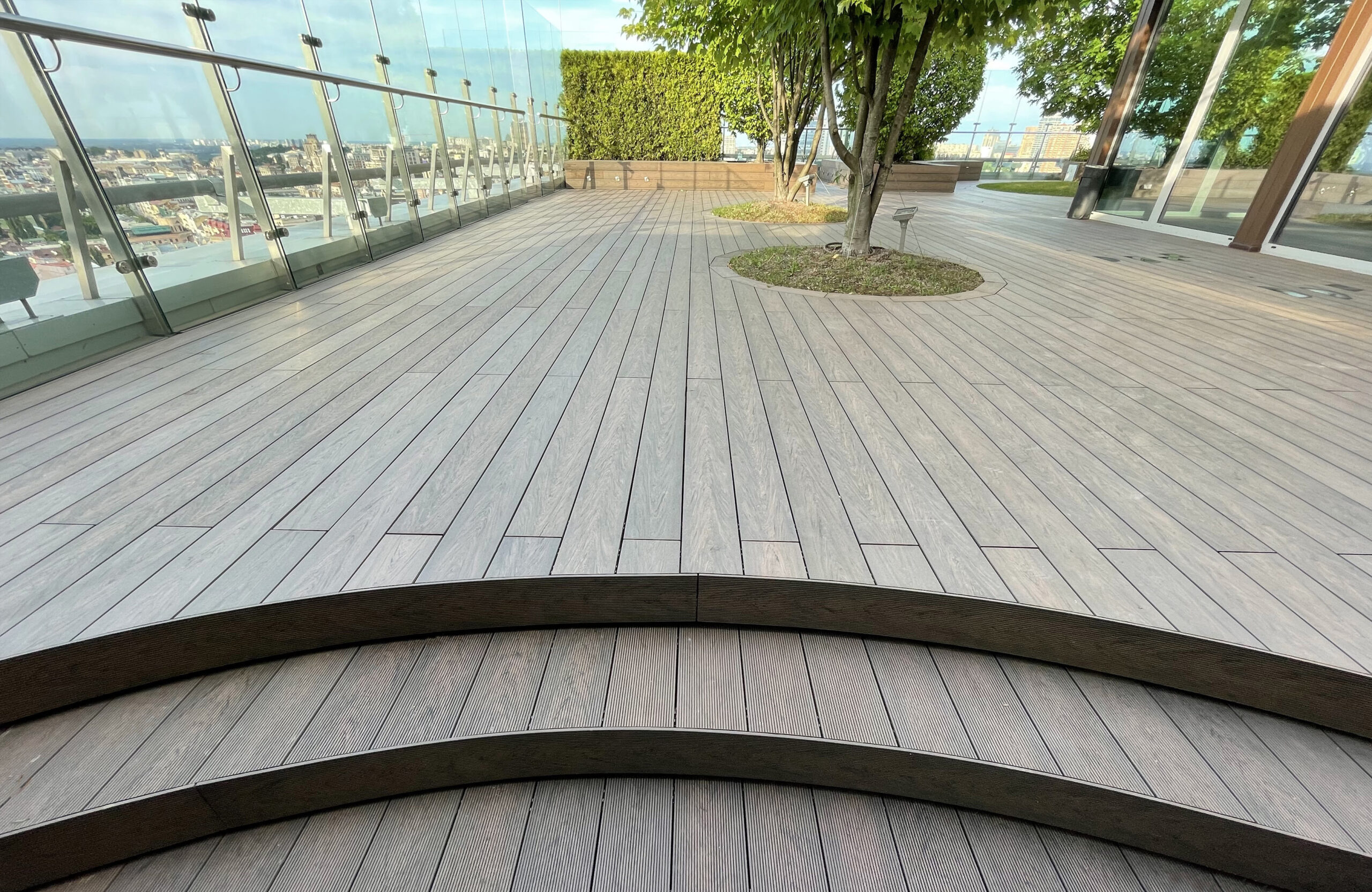 Rooftop landscape park in Kyiv with BRUGGAN Multicolor Wenge composite decking and integrated planters