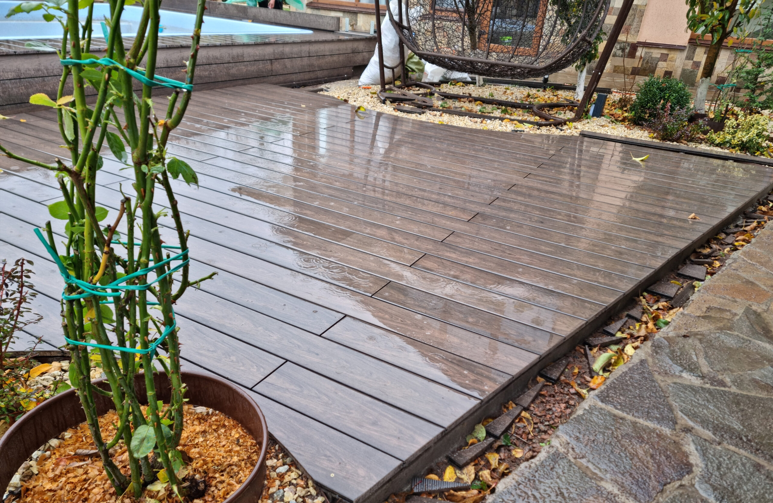 BRUGGAN Multicolor Wenge outdoor decking surrounding a raised swimming pool in a private backyard