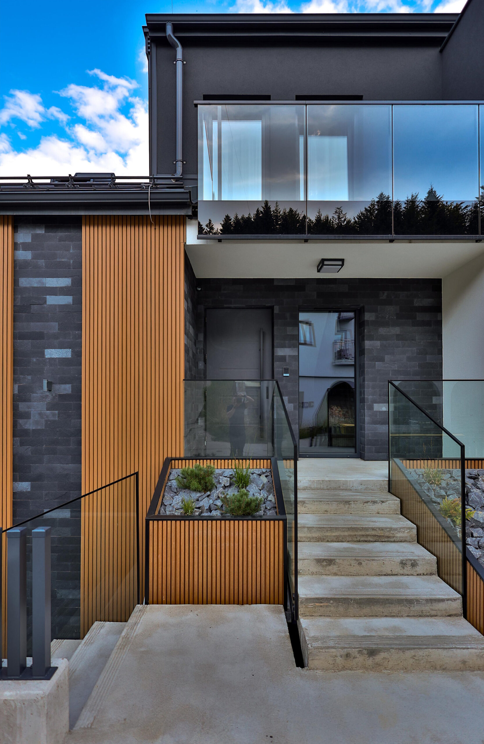 LEGRO Maple facade boards combined with dark stone and glass elements