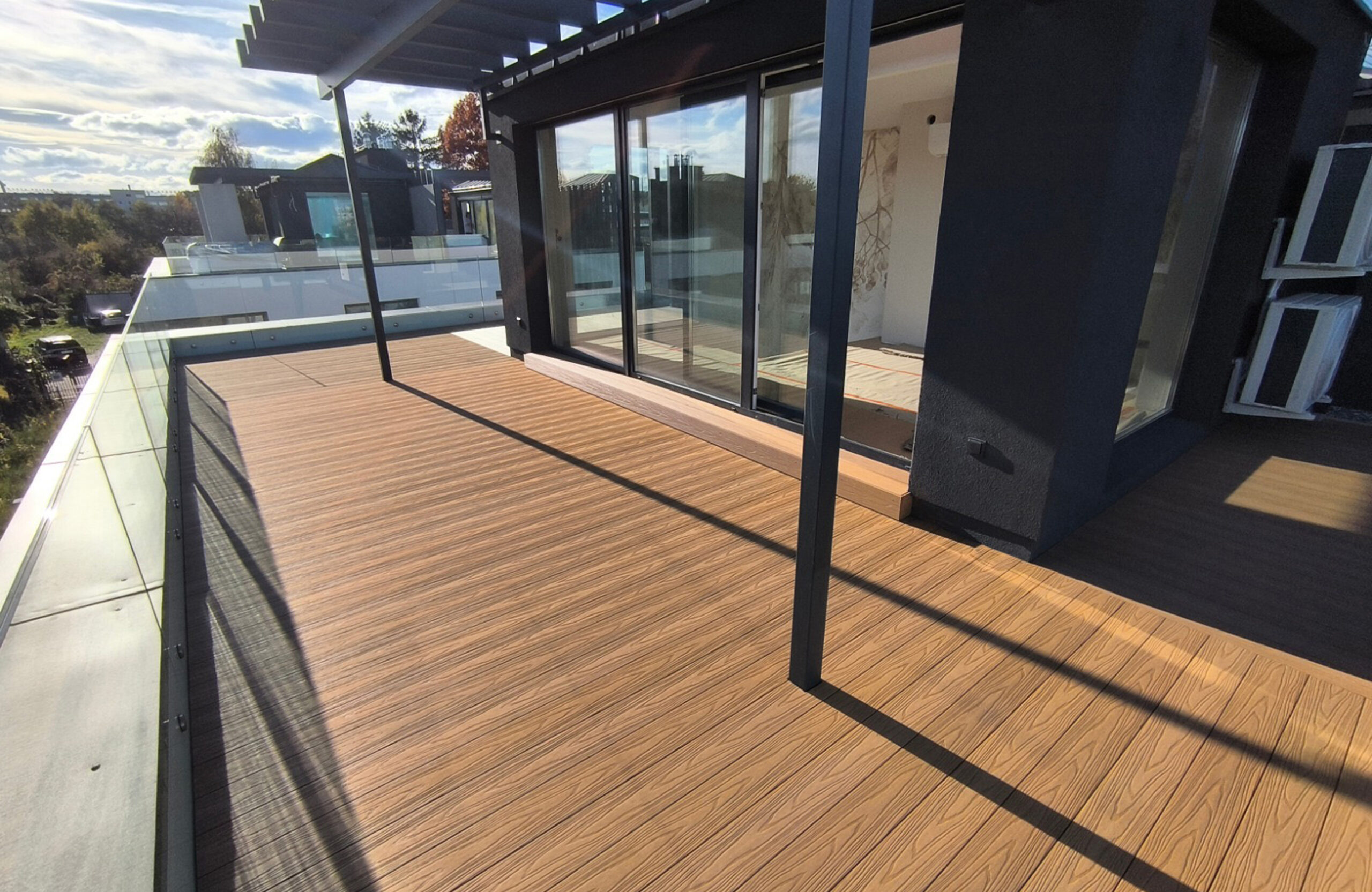 Spacious rooftop terrace finished with Legro Maple composite decking and glass balustrade