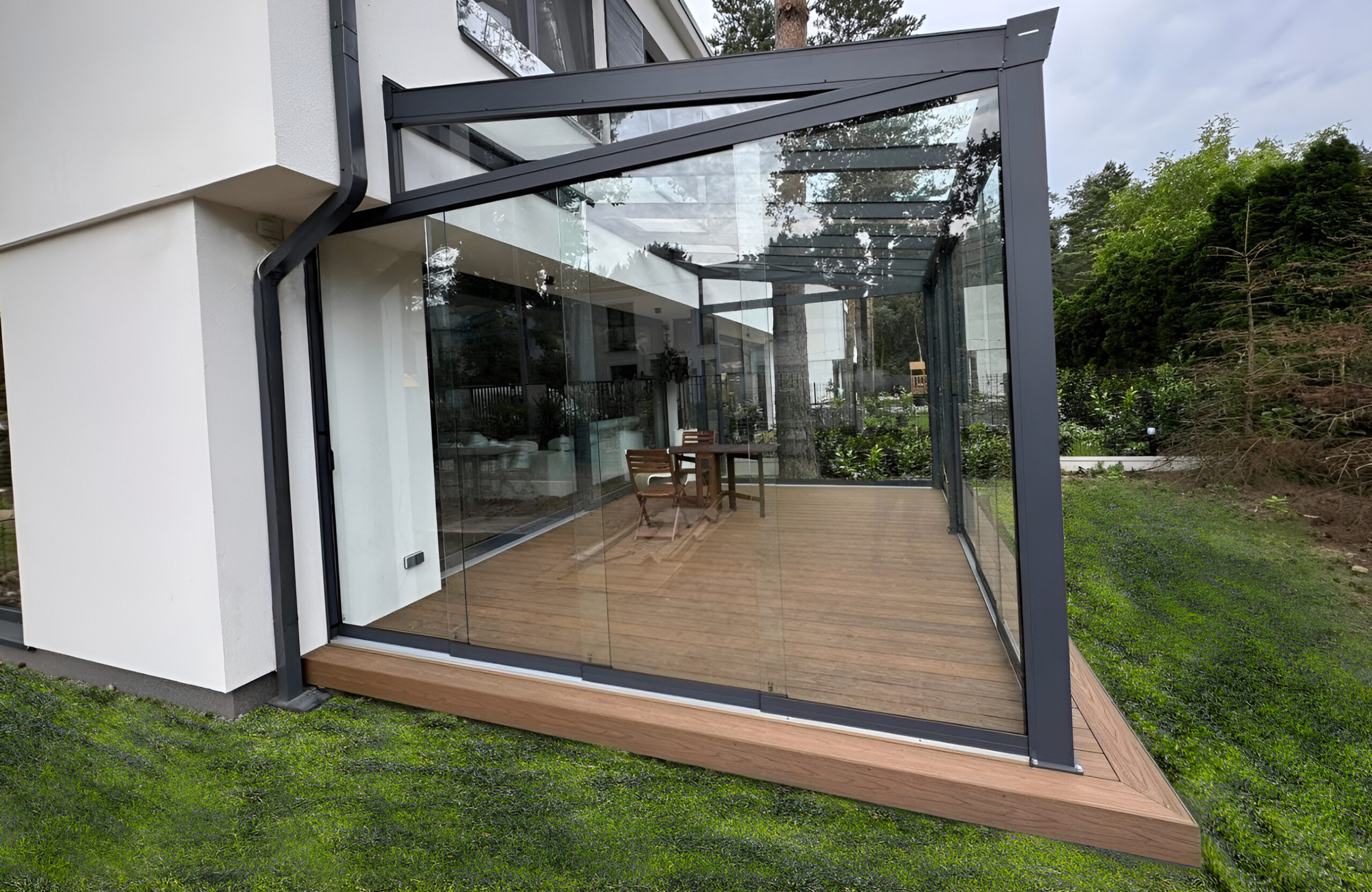 Modern glass-enclosed terrace with Legro Teak composite decking and black aluminum frame
