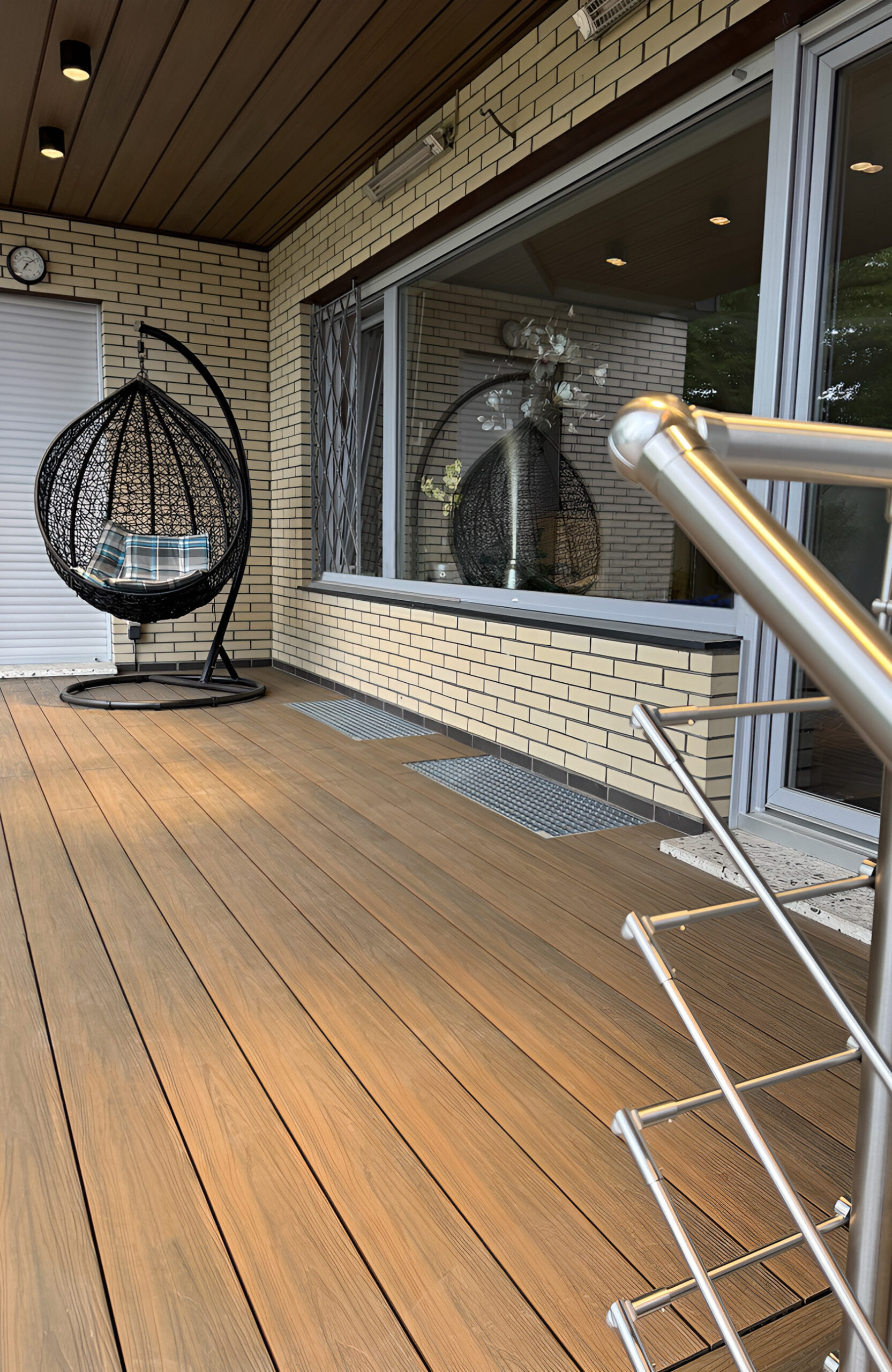 LEGRO teak composite decking terrace with matching steps, stainless steel railing and modern outdoor seating