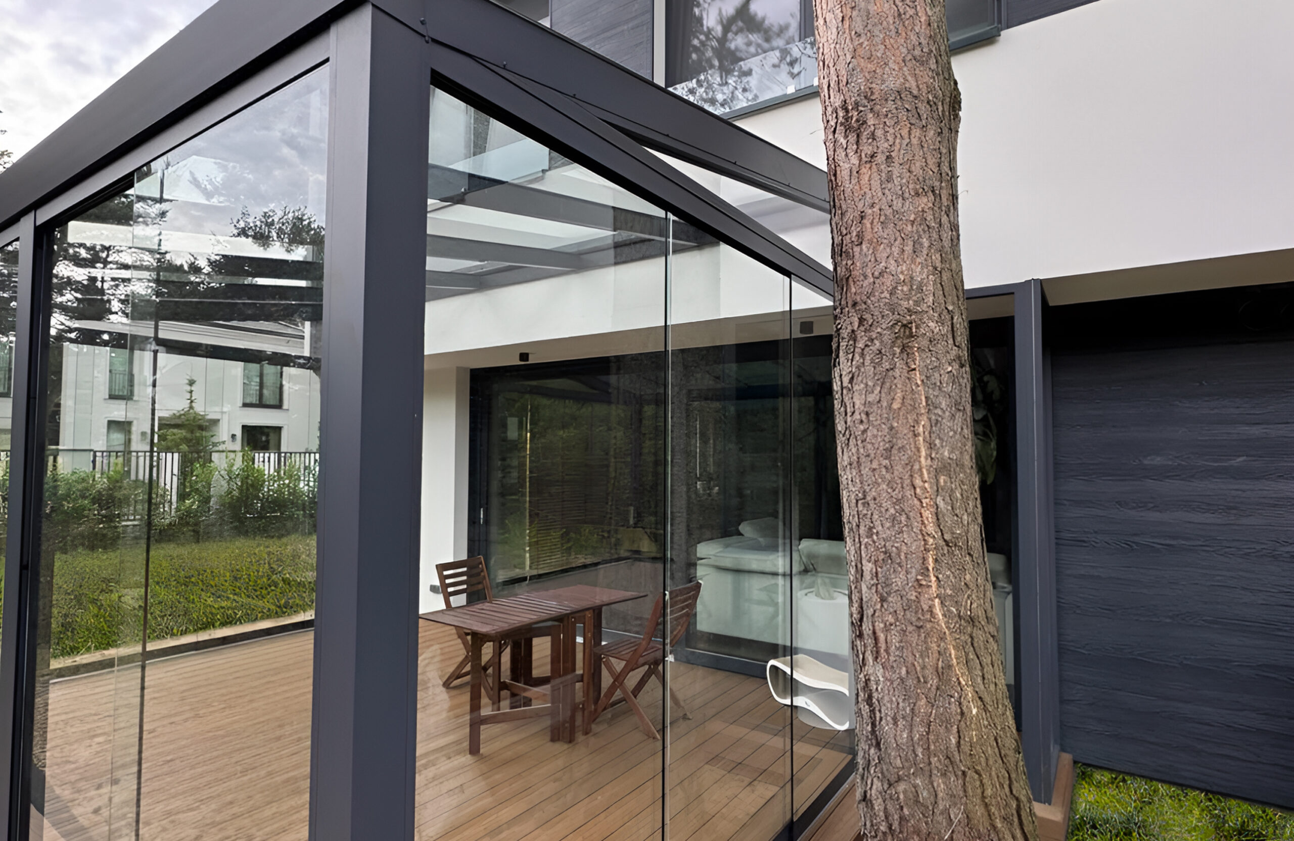 Contemporary glass veranda with Legro Teak WPC decking and panoramic sliding glass walls