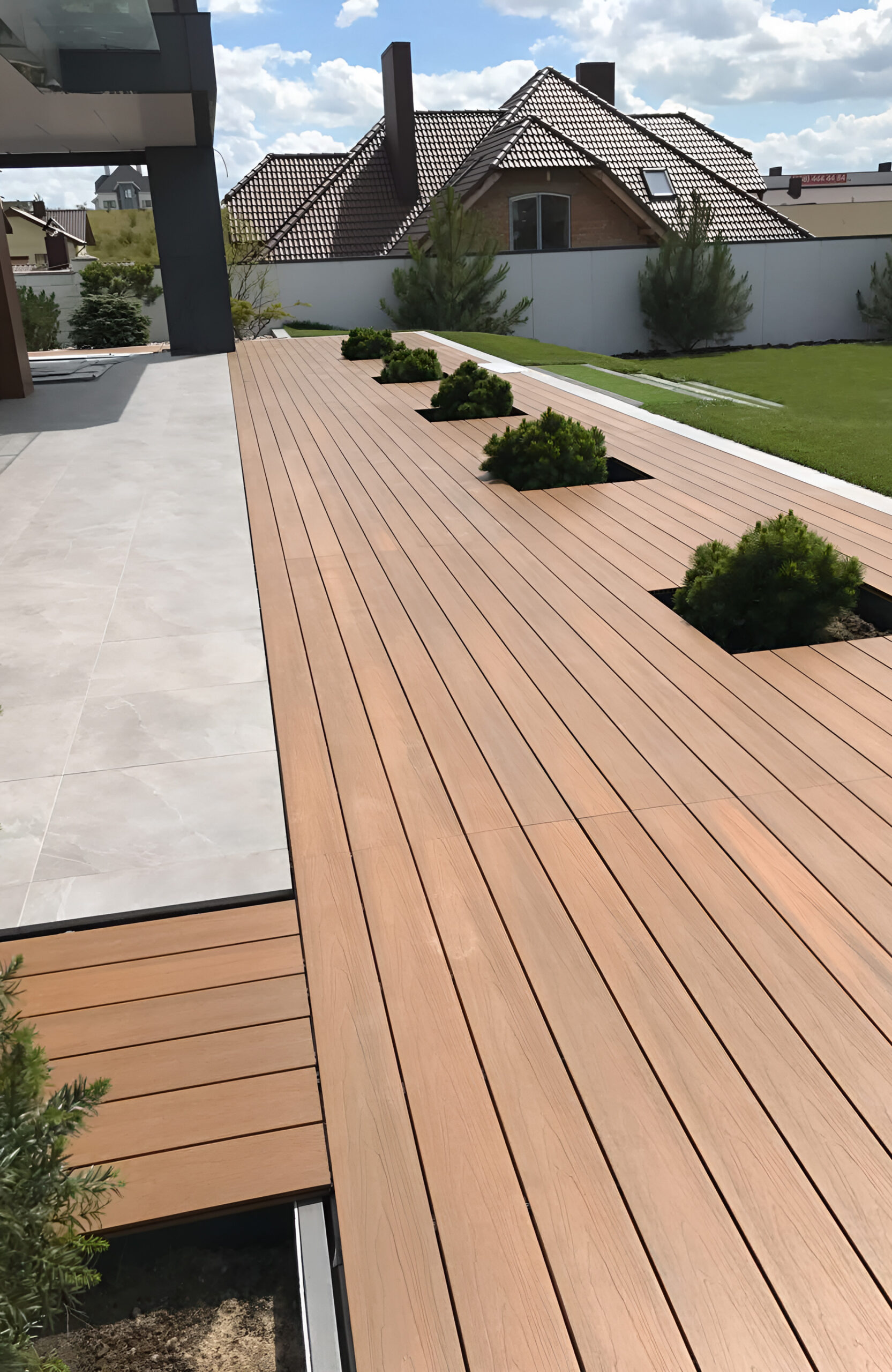 Modern terrace with LEGRO teak composite decking and integrated green planters
