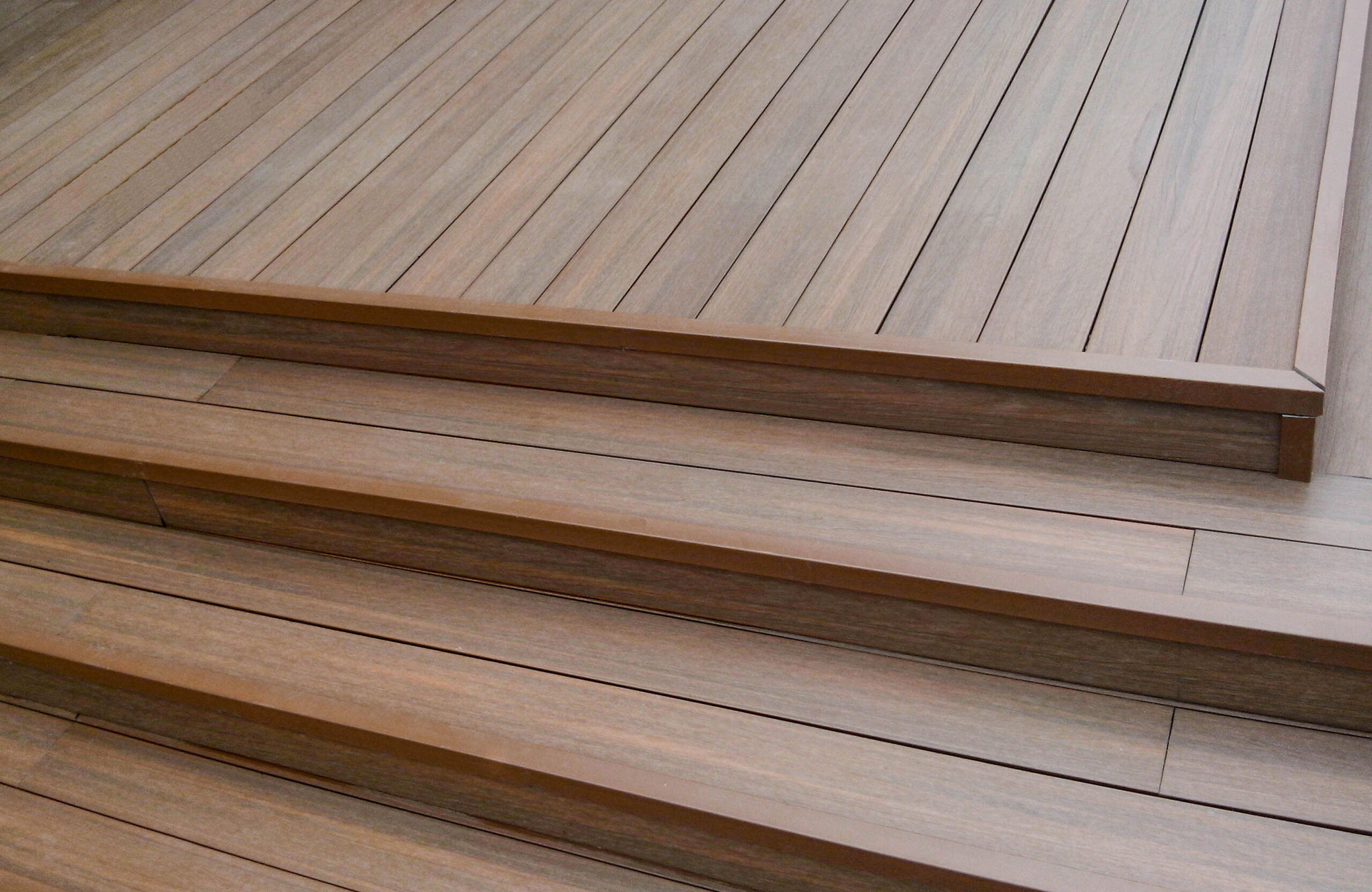 Close-up of LEGRO teak WPC decking with matching composite steps and edge finishing