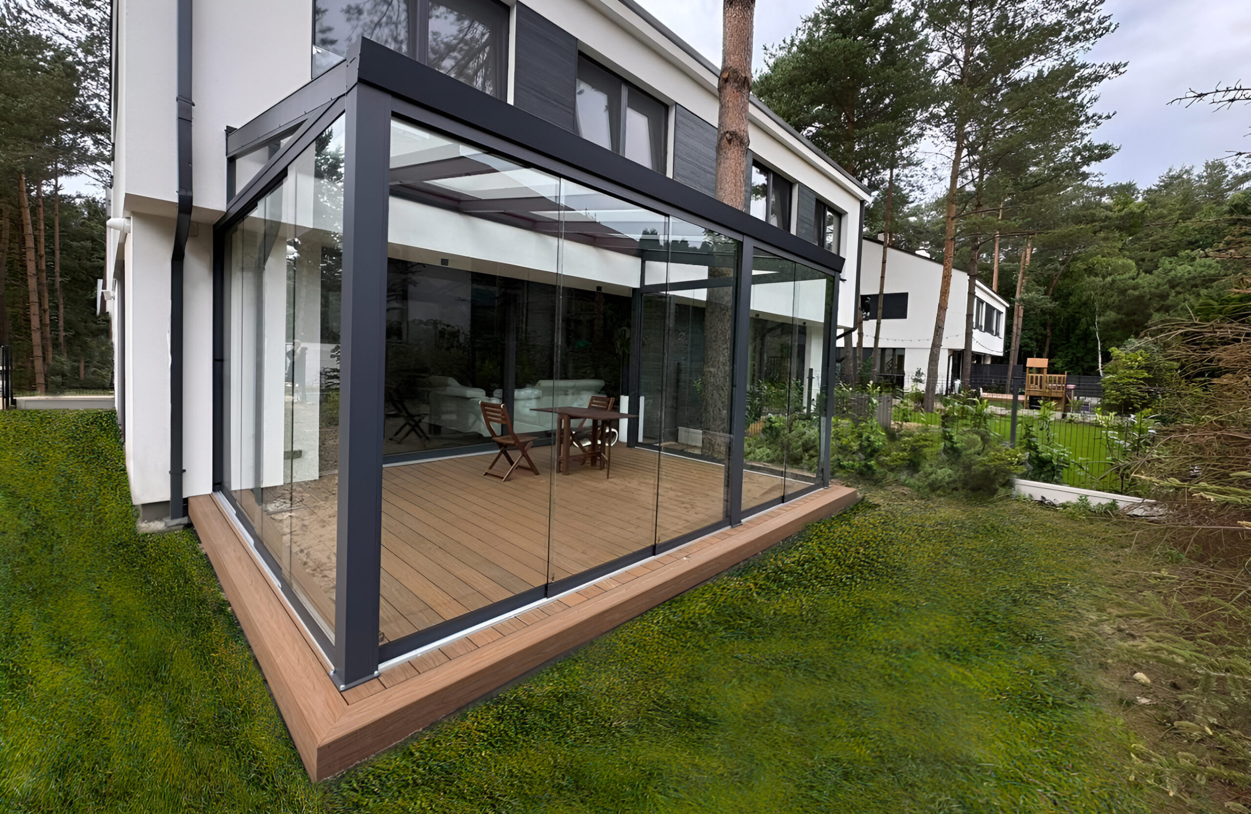 Modern glazed terrace with teak-colored WPC decking and aluminum frame attached to a contemporary house