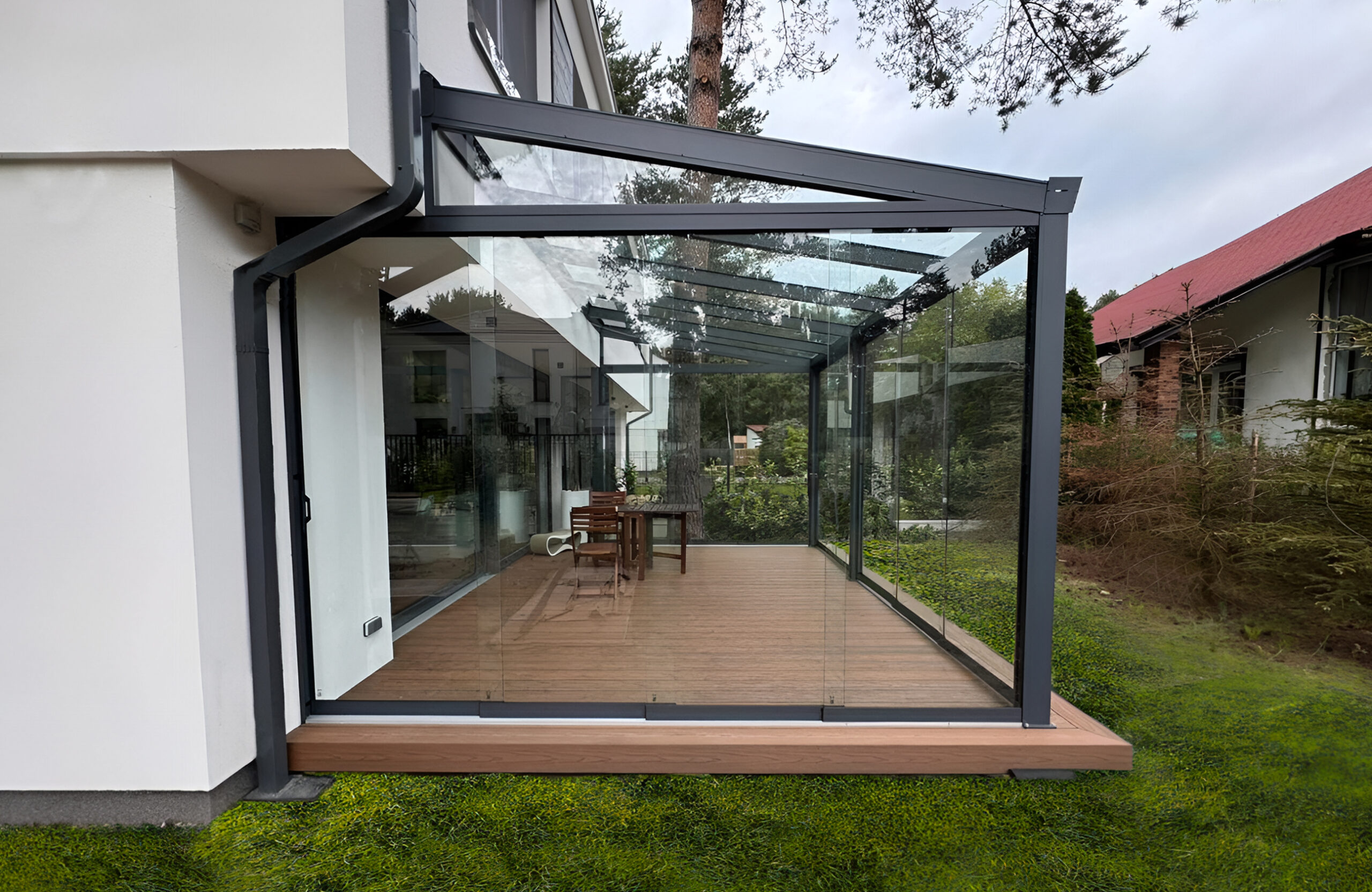 Modern glazed terrace with teak-colored WPC decking and aluminum frame attached to a contemporary house