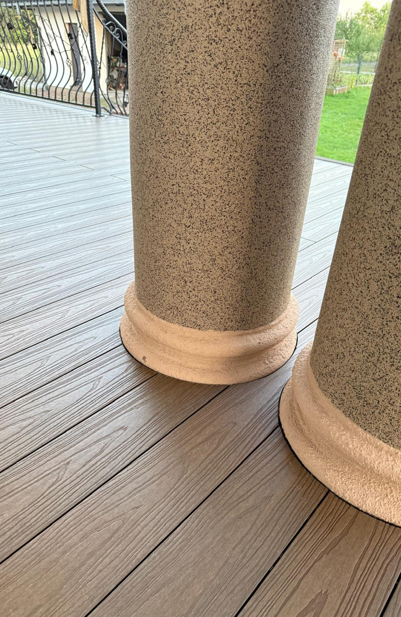 Durable and low-maintenance composite wood terrace decking installed on a home patio, featuring a realistic wood grain finish and a teak color