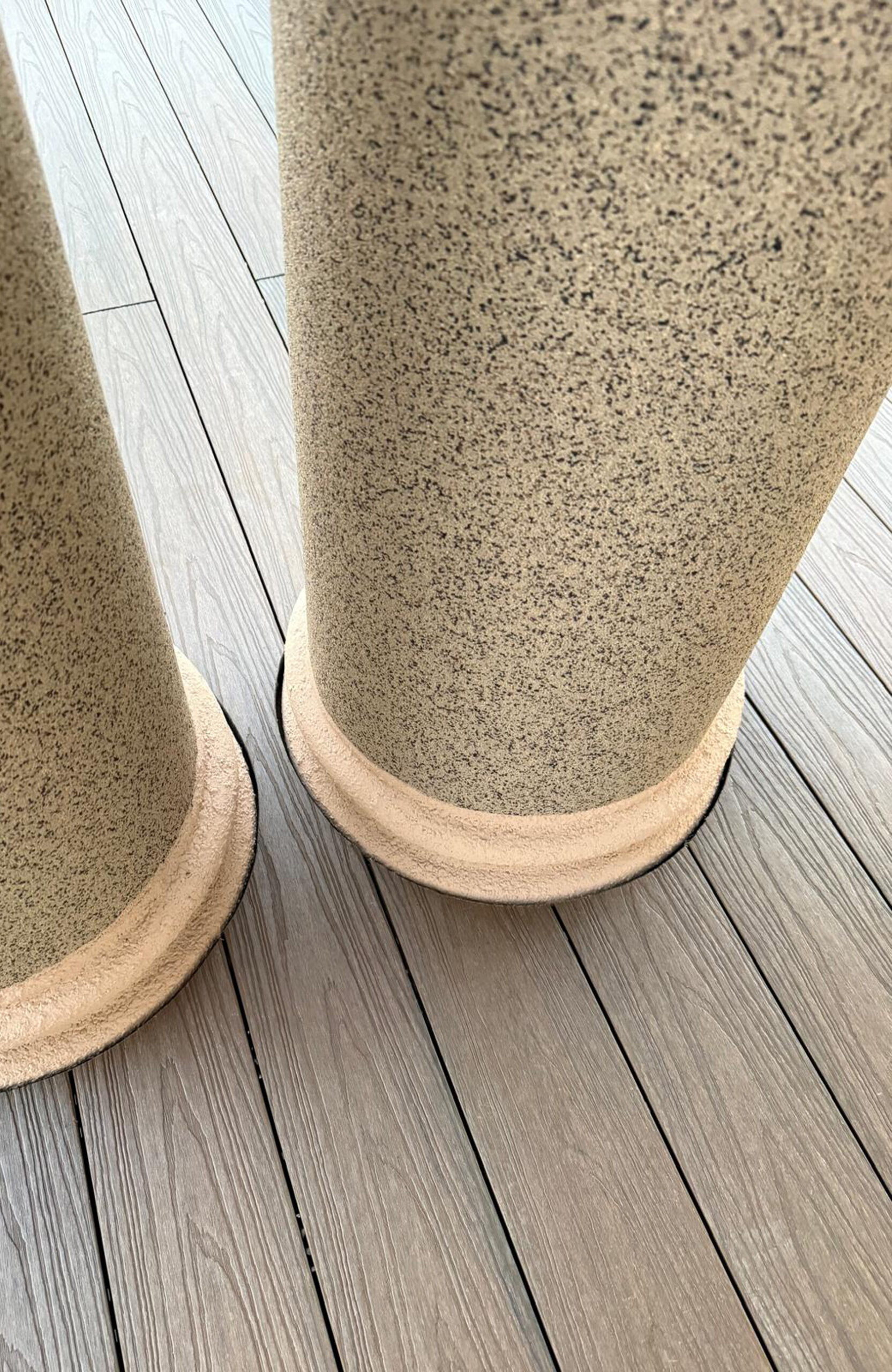 Durable and low-maintenance composite wood terrace decking installed on a home patio, featuring a realistic wood grain finish and a teak color