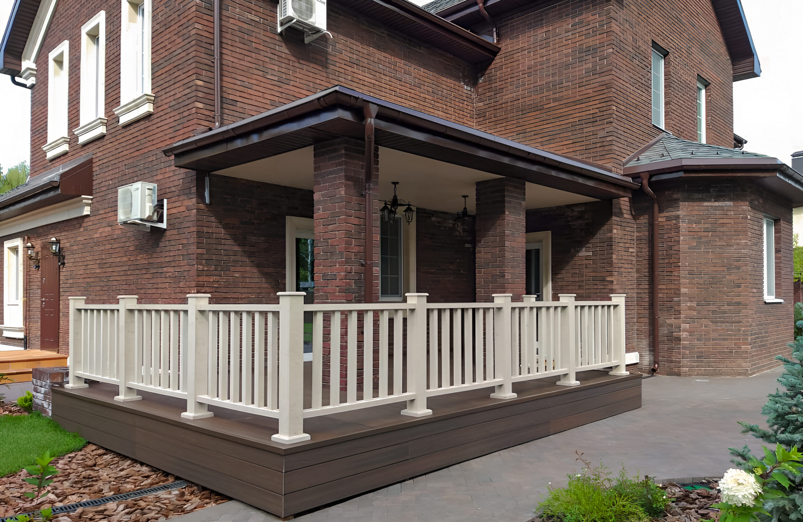 Covered terrace with LEGRO walnut composite decking and white railing