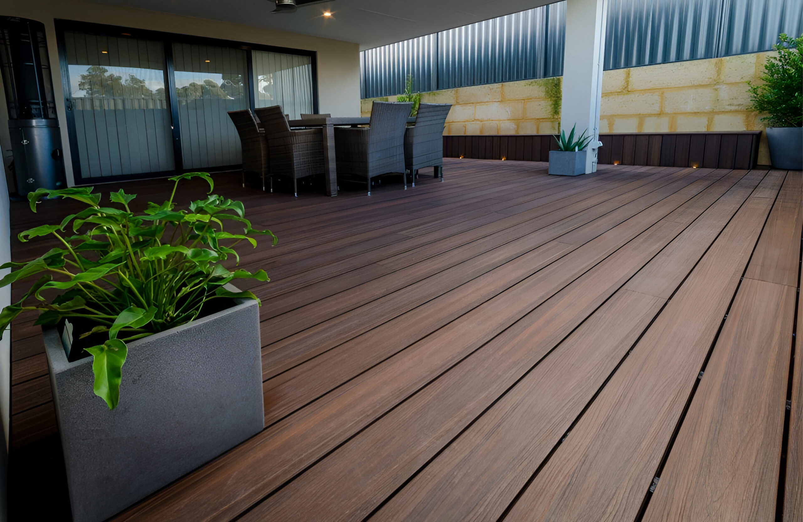 Covered terrace with LEGRO walnut composite decking and outdoor dining area
