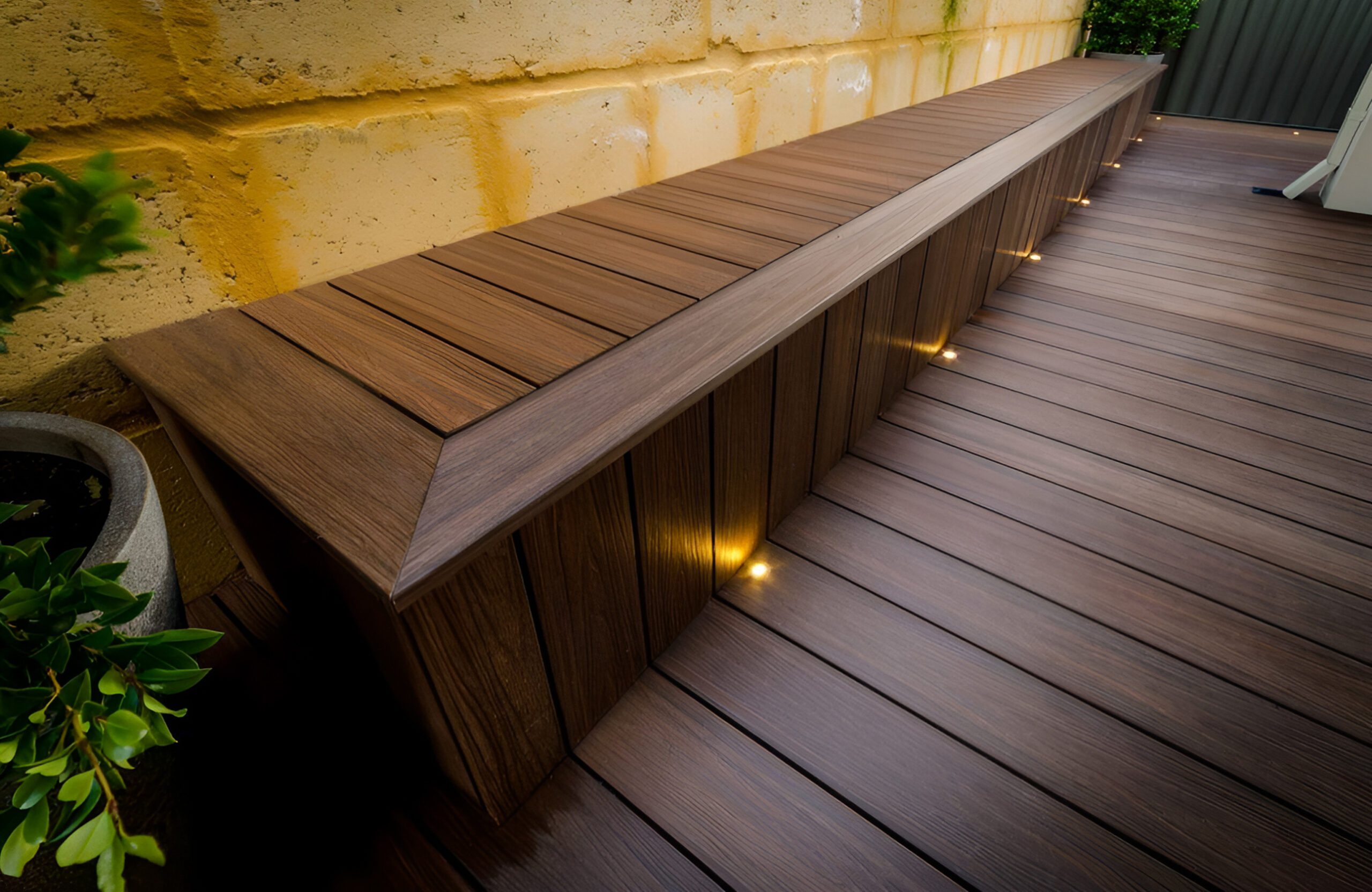Built-in bench made with LEGRO walnut composite decking and integrated lighting