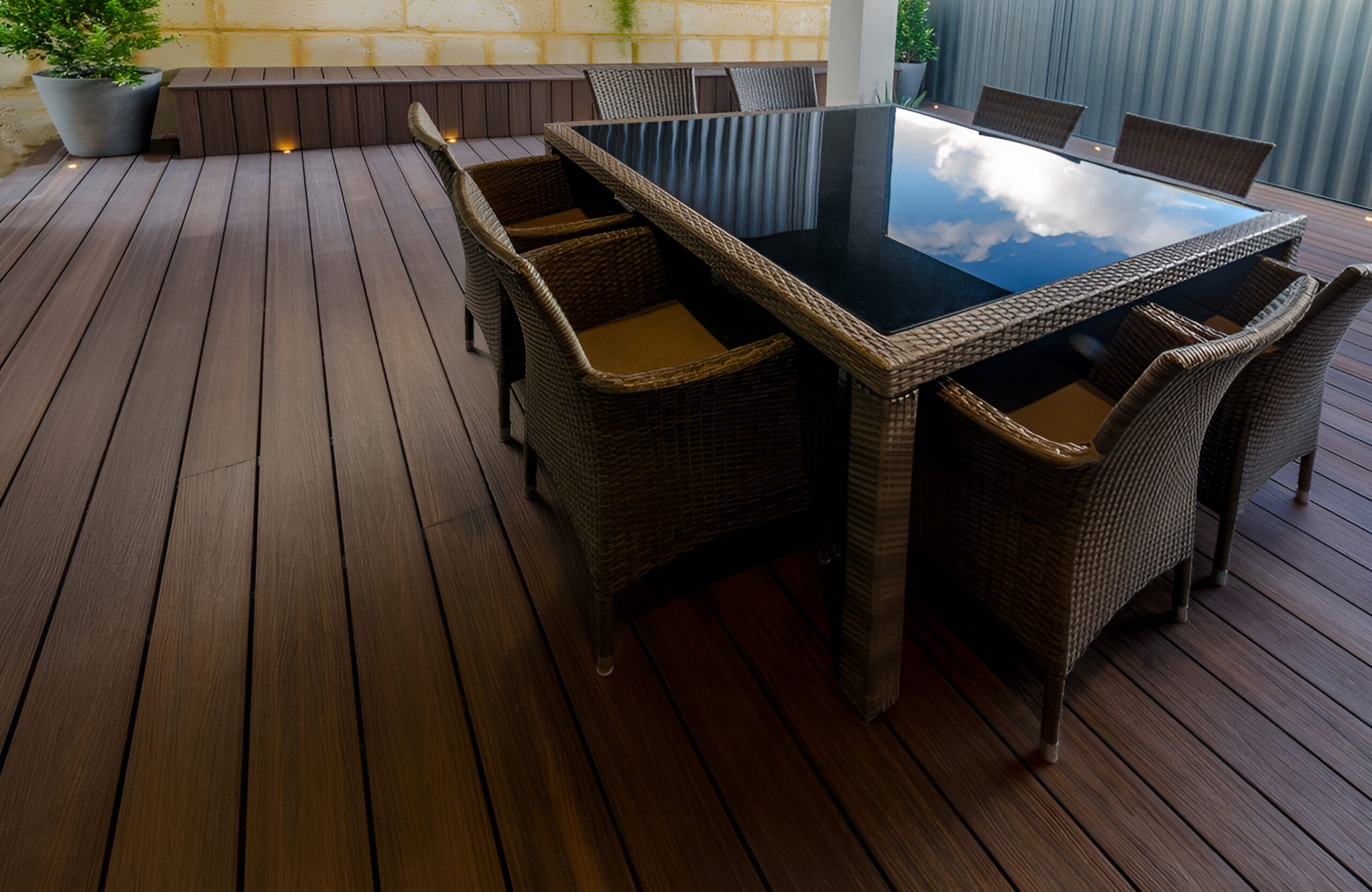 Outdoor dining area on LEGRO walnut composite decking with built-in seating