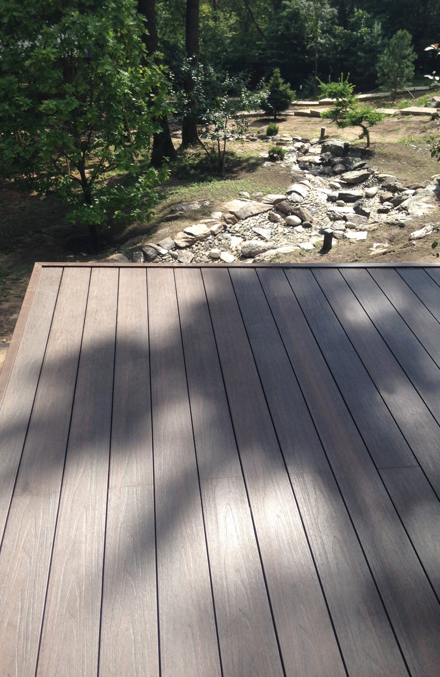 LEGRO walnut composite decking overlooking a landscaped garden